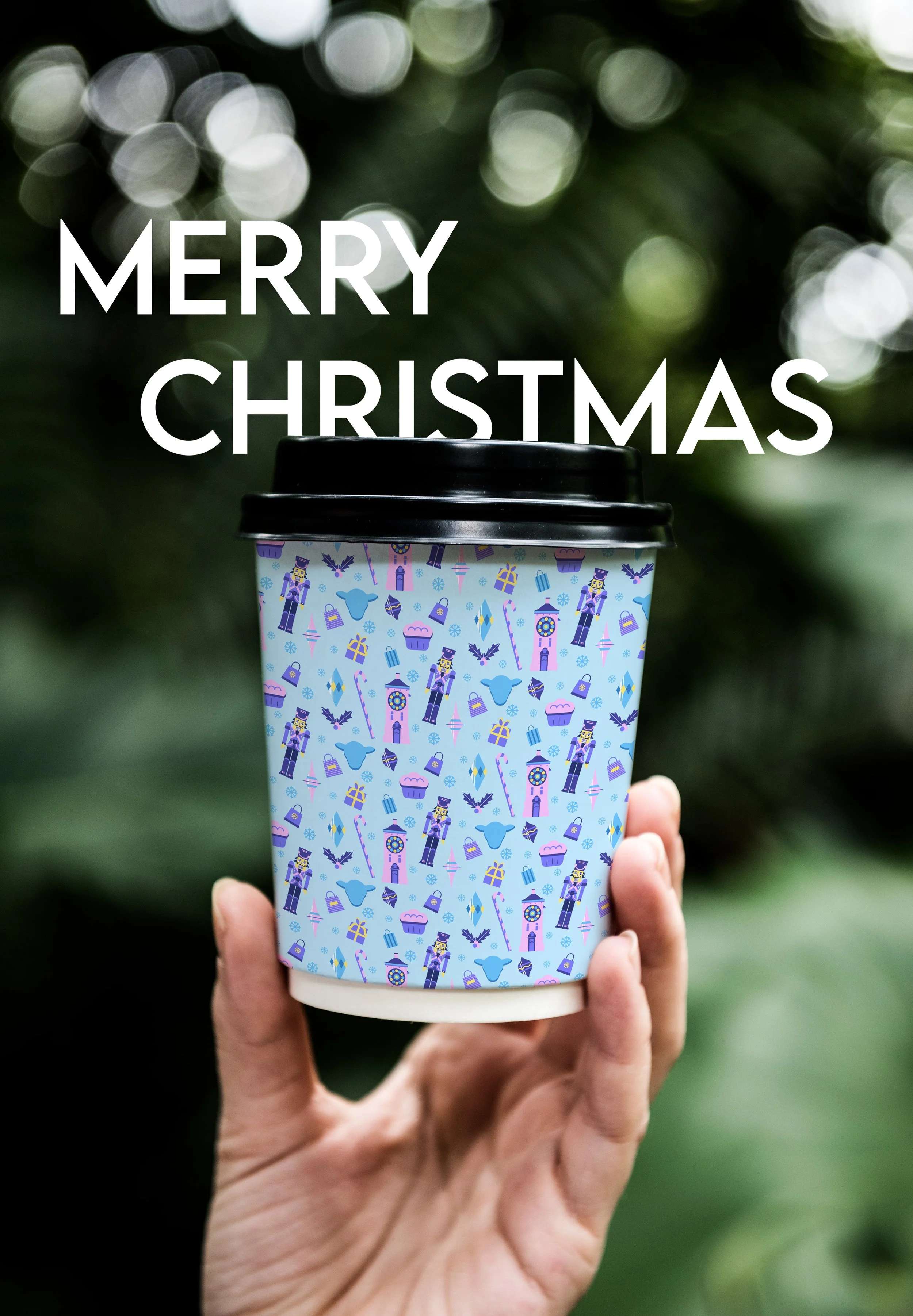 A hand holding a coffee cup with a Christmas-themed sleeve featuring nutcrackers, candy canes, presents, and trees, with a bokeh green background. Overlaid text says 'Merry Christmas'.
