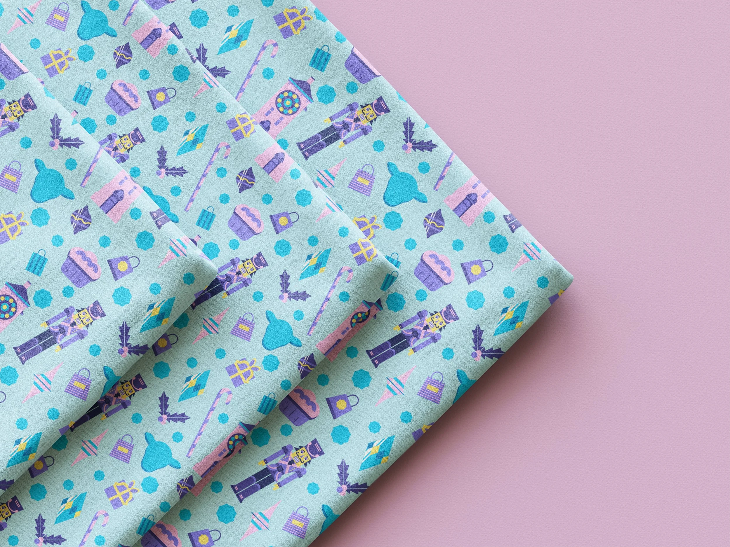 A close-up of pastel-colored gift wrap with holiday-themed patterns, including nuts, candy canes, snowflakes, and presents, on a pink background.