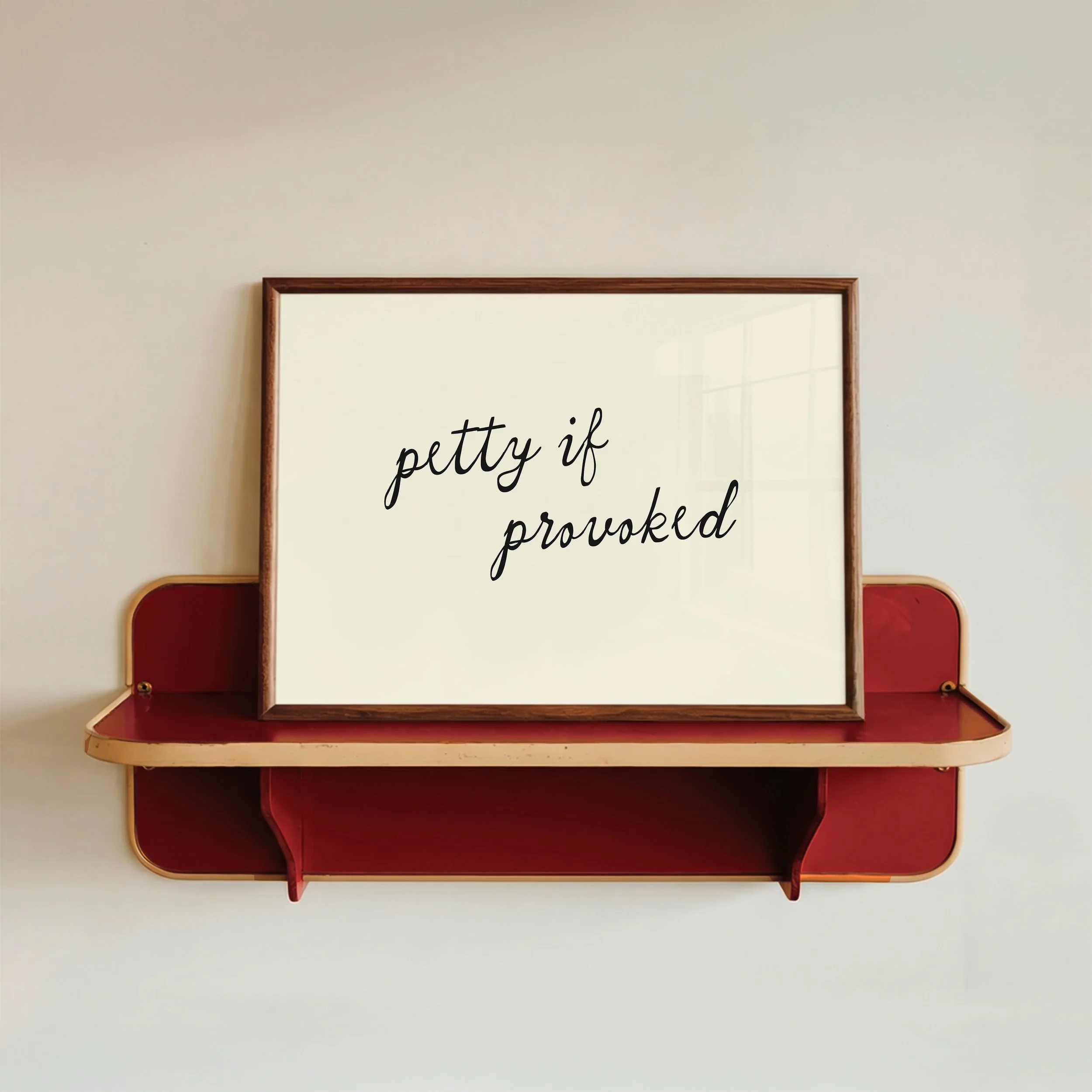 petty if provoked typography print in cream with black script font, framed on red wall shelf, minimal modern home decor, sarcastic quote art