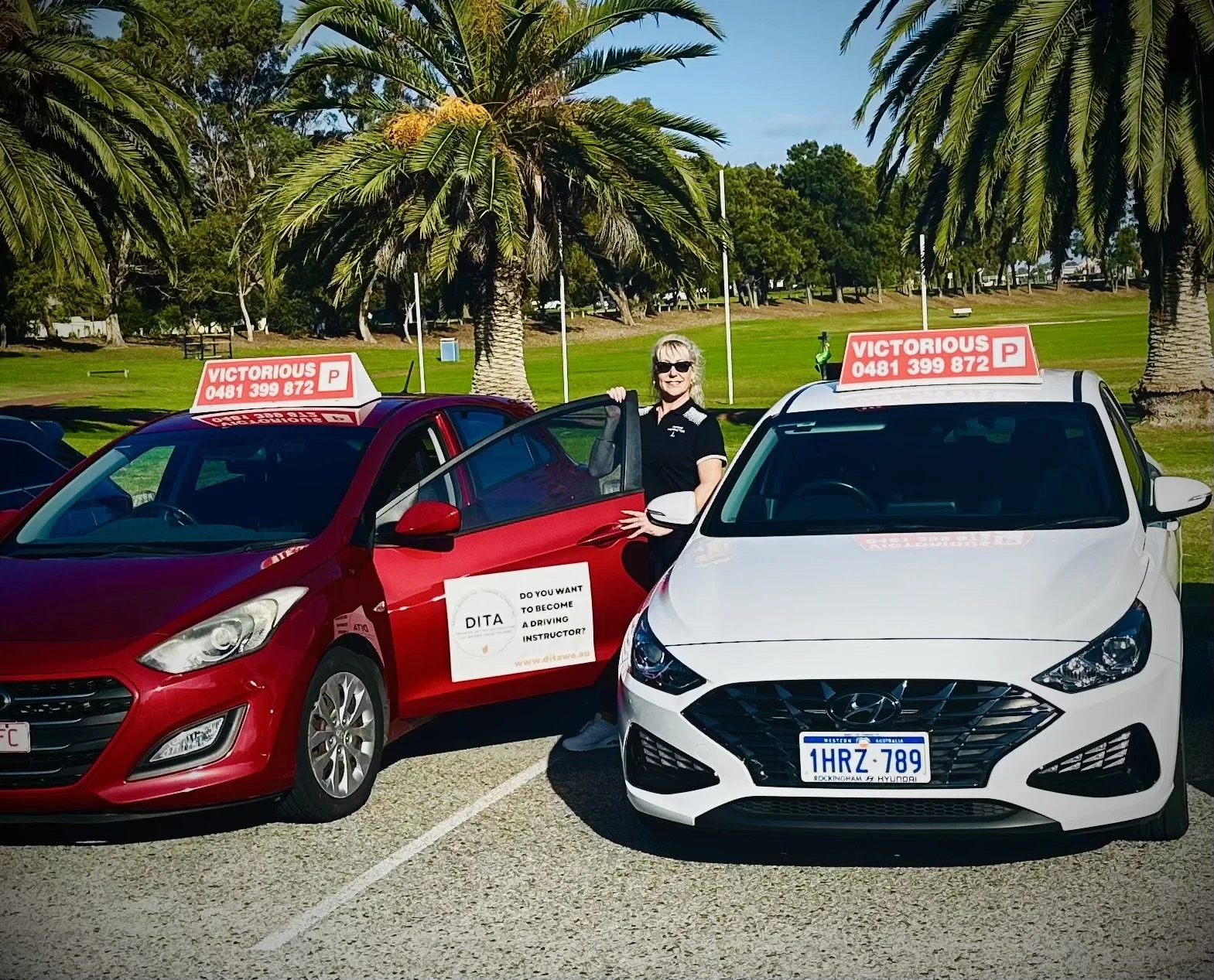 Vicky standing and holding her car door outside in front of a field.