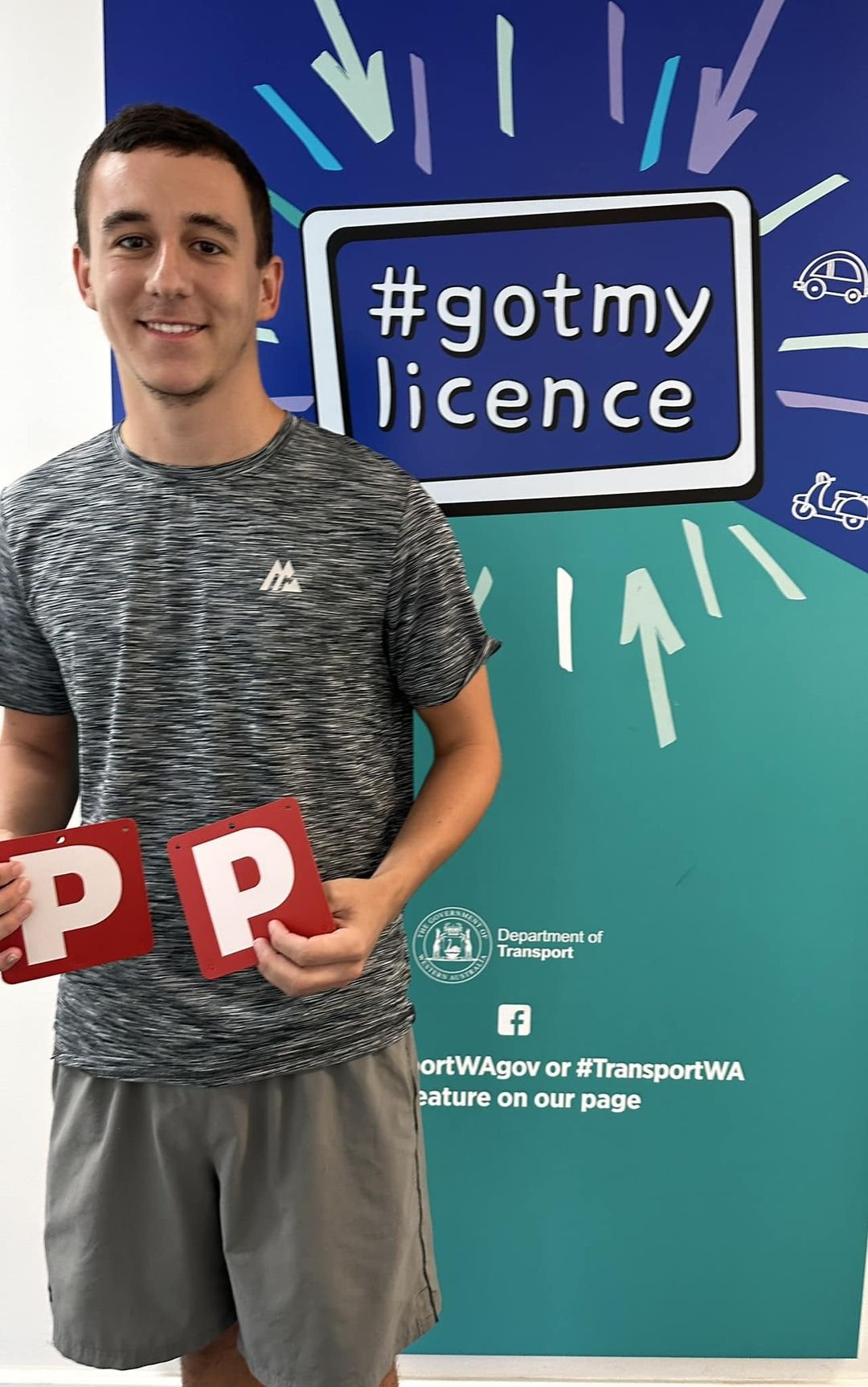 Victorious Driving School student Kyle holding their Red P plates after passing their PDA.