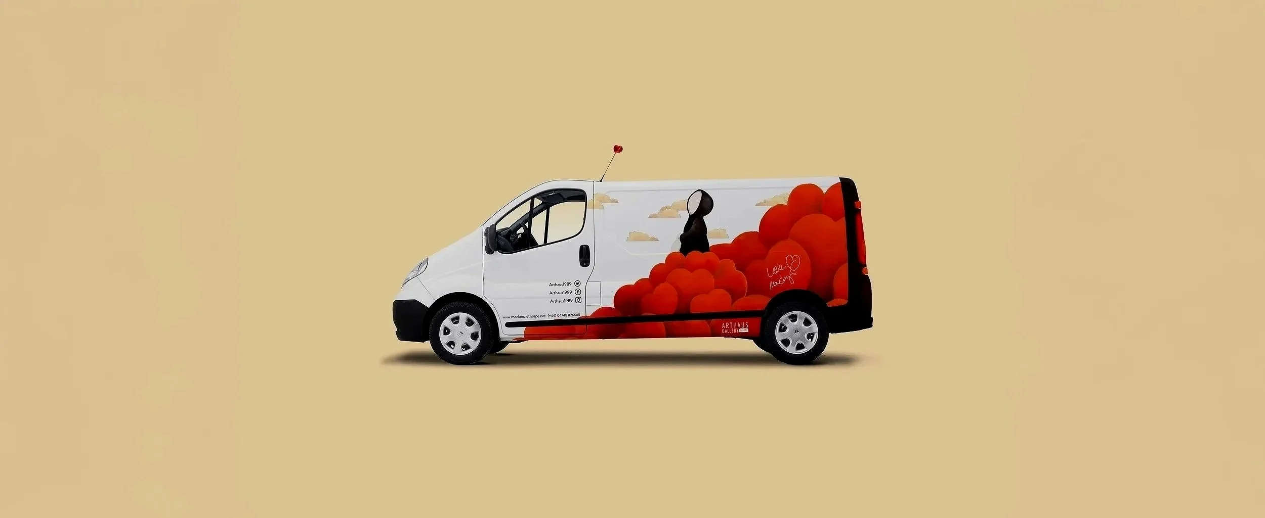White van with a colorful graphic of red balloons and a black and white figure on its side, set against a beige background.