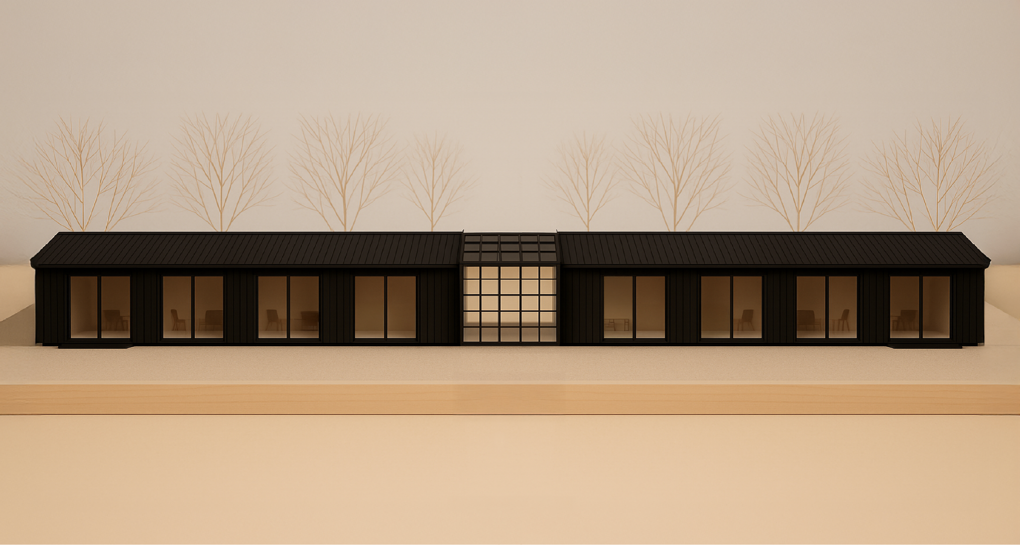 Architectural model of a modern, black, elongated building with large glass windows, set against a background wall with faint tree outline drawings.