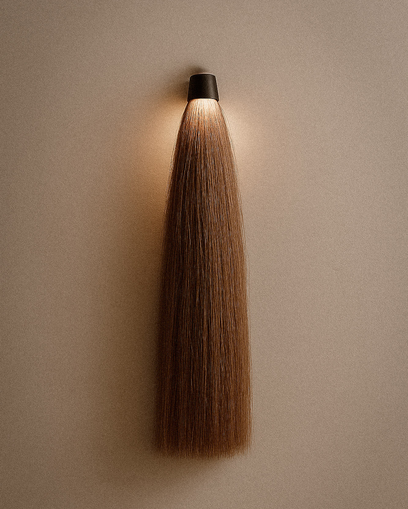 A sleek, modern wall-mounted light fixture resembling a wig or hairpiece, with a black top and brown hair flowing downward.