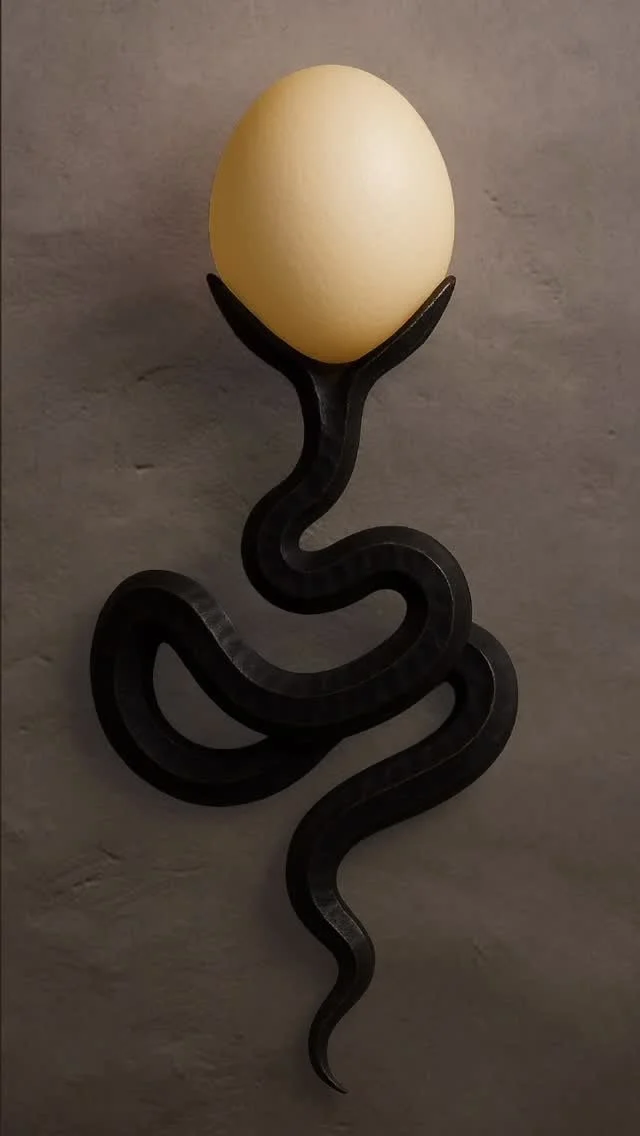 A black, wavy, snake-shaped sculpture holding a white, oval-shaped egg against a gray wall background.
