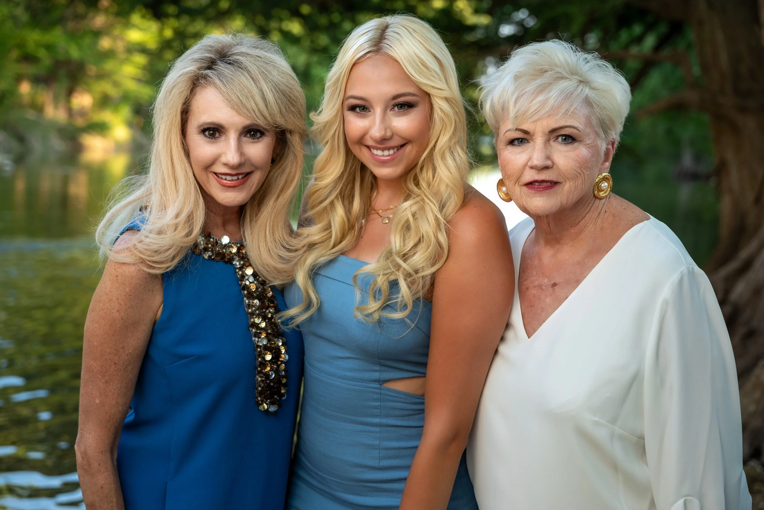 Generational family smiling together and posed on the banks of the Guadalupe River near San Antonio, TX.