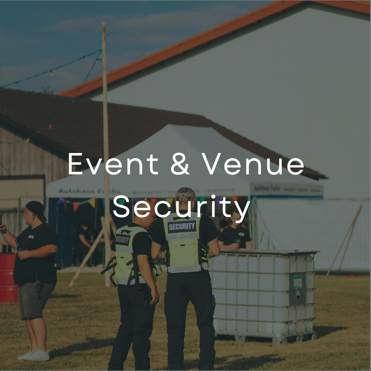 Security staff present at an outdoor event with tents and equipment.