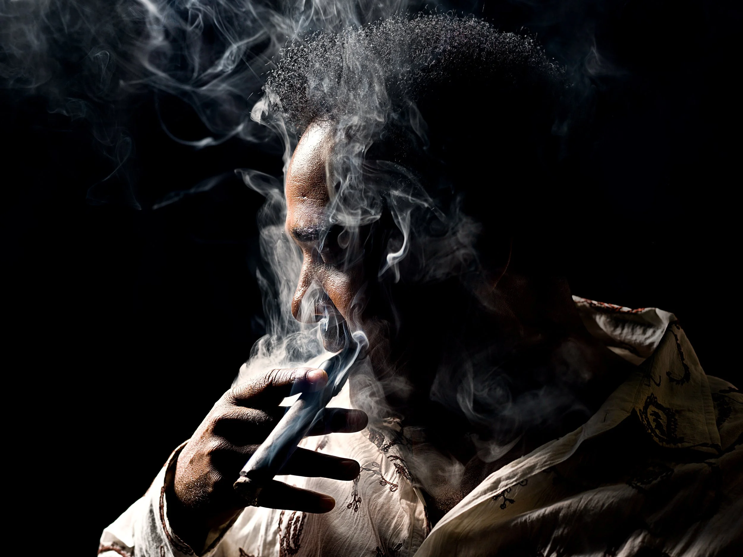 Edgy portrait of a man smoking by Oliver Solomon