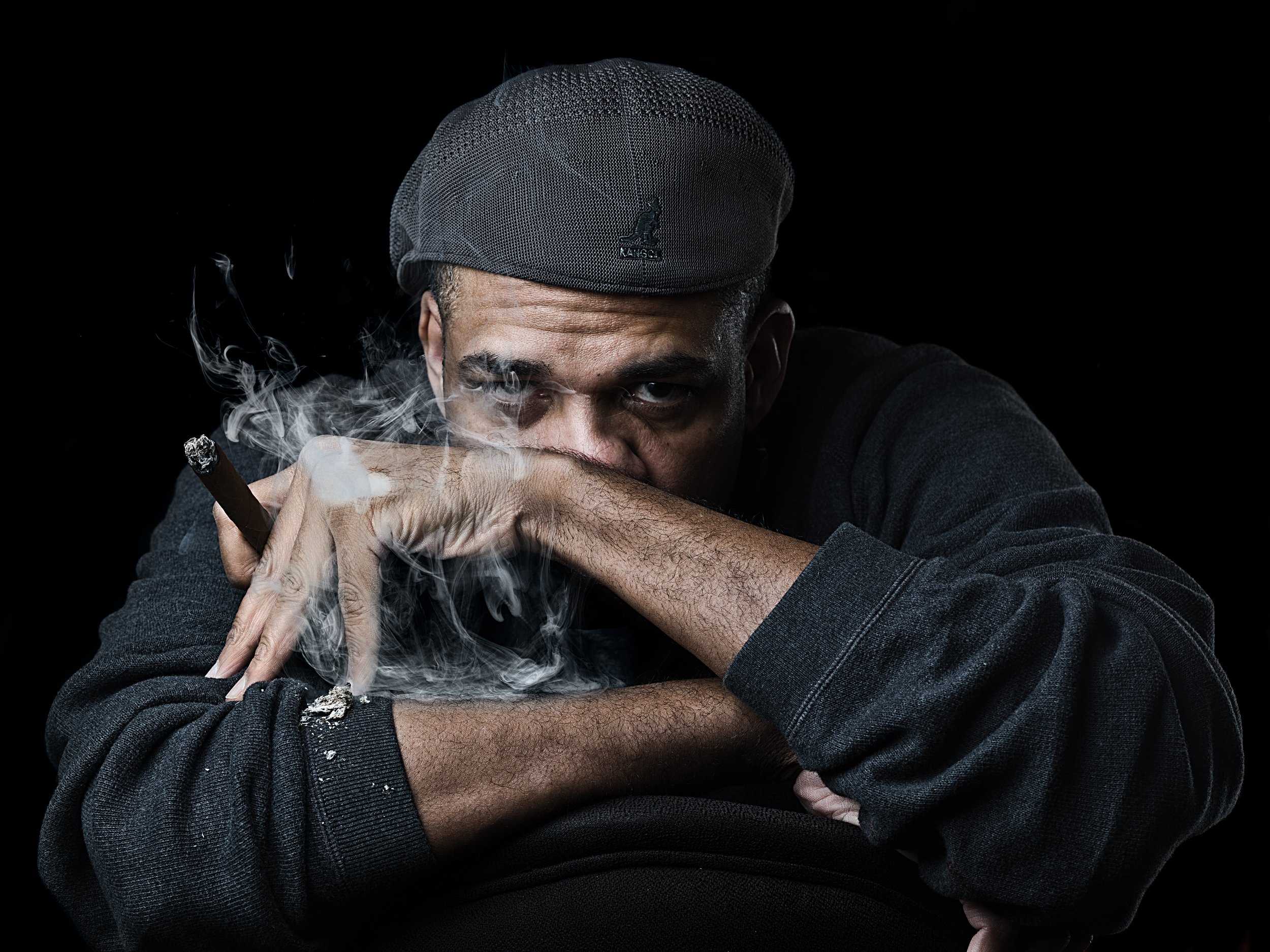 Attractive Black Man Smoking in a Portrait by Oliver Solomon