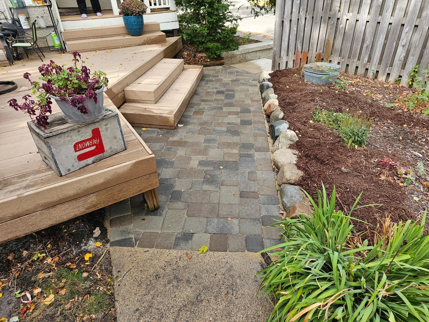 Paver landing with natural boulder edging alongside garden bed — Longfellow Minneapolis MN — Heritage Outdoors 2024