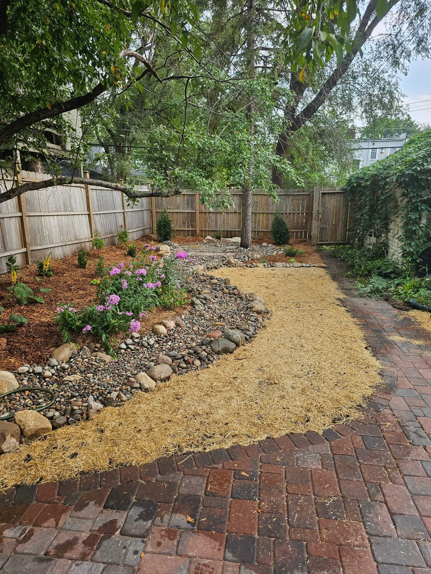 Completed landscape with dry creek bed and patio — Hamline-Midway Saint Paul MN — Heritage Outdoors 2025