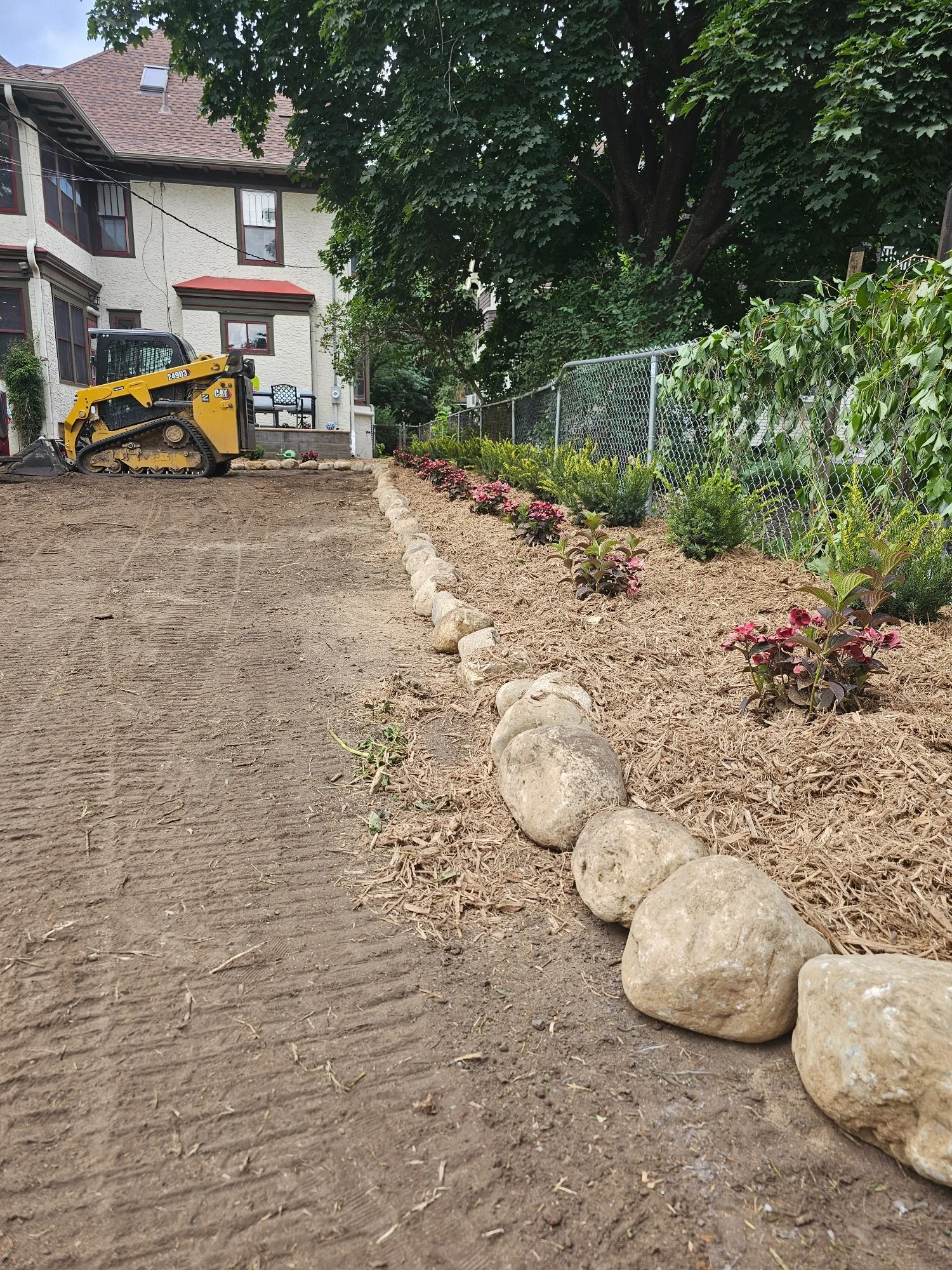 Boulder edging garden bed long view during installation — Summit Hill Saint Paul MN — Heritage Outdoors 2025