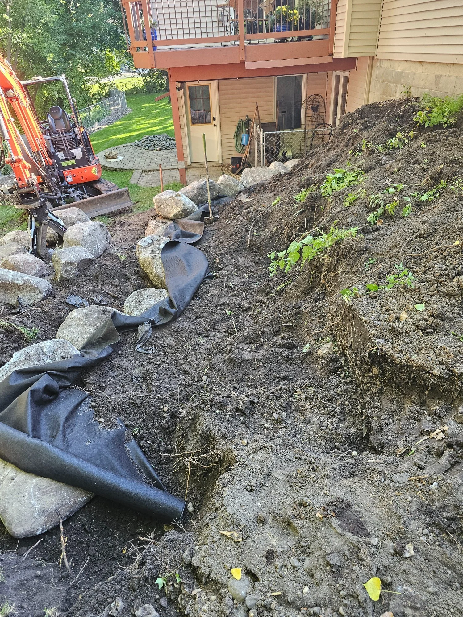 Boulder wall excavation with boulder fabric base preparation — Woodbury MN — Heritage Outdoors 2025