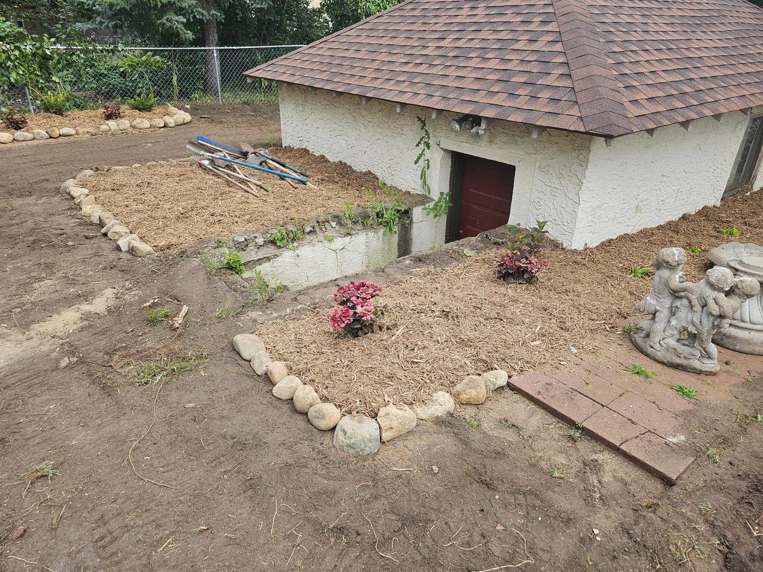 Boulder edged garden beds during installation — Summit Hill Saint Paul MN — Heritage Outdoors 2025
