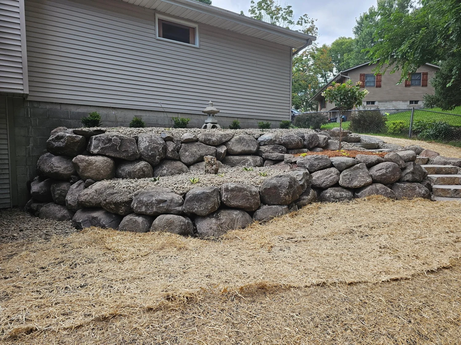 Completed tiered boulder retaining wall front view — Woodbury MN — Heritage Outdoors 2025