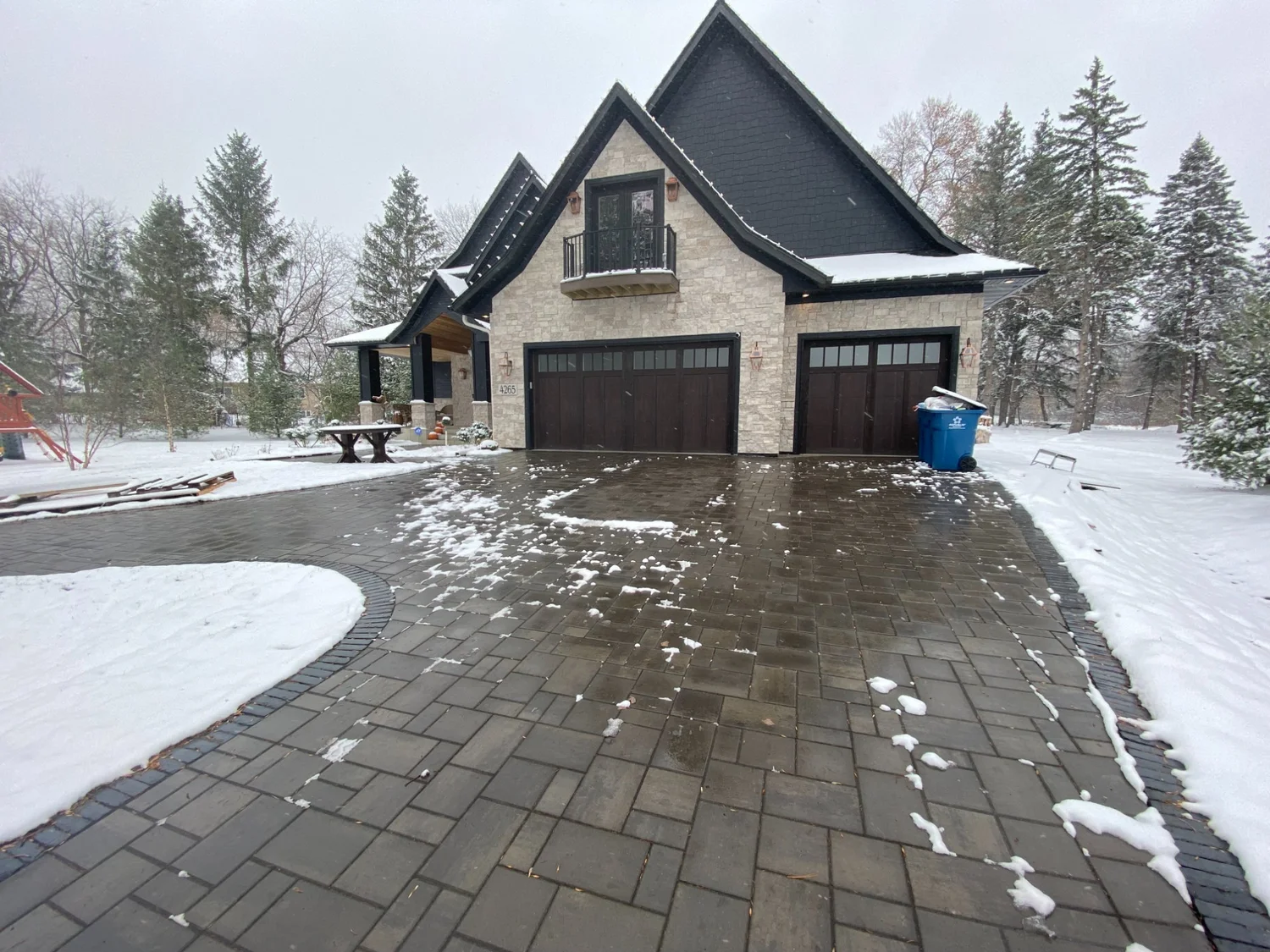 Unilock Treo Smooth paver driveway in winter snow — Plymouth MN — Heritage Outdoors