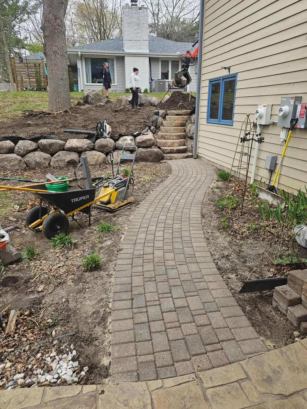 Boulder wall steps with relaid paver walkway — Burnsville MN — Heritage Outdoors 2025