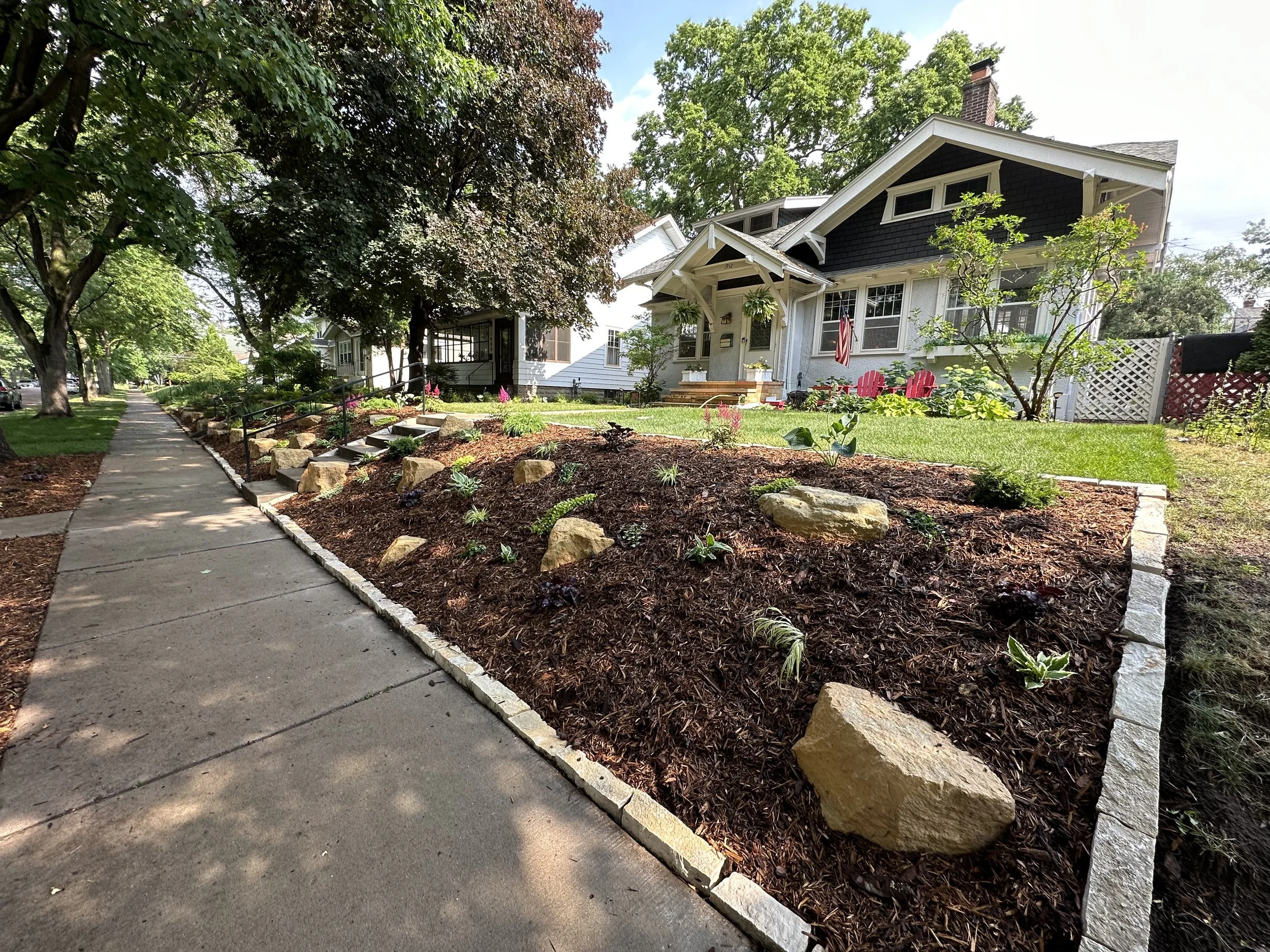 Completed limestone outcropping front yard landscape design — Macalester-Groveland Saint Paul MN — Heritage Outdoors 2023