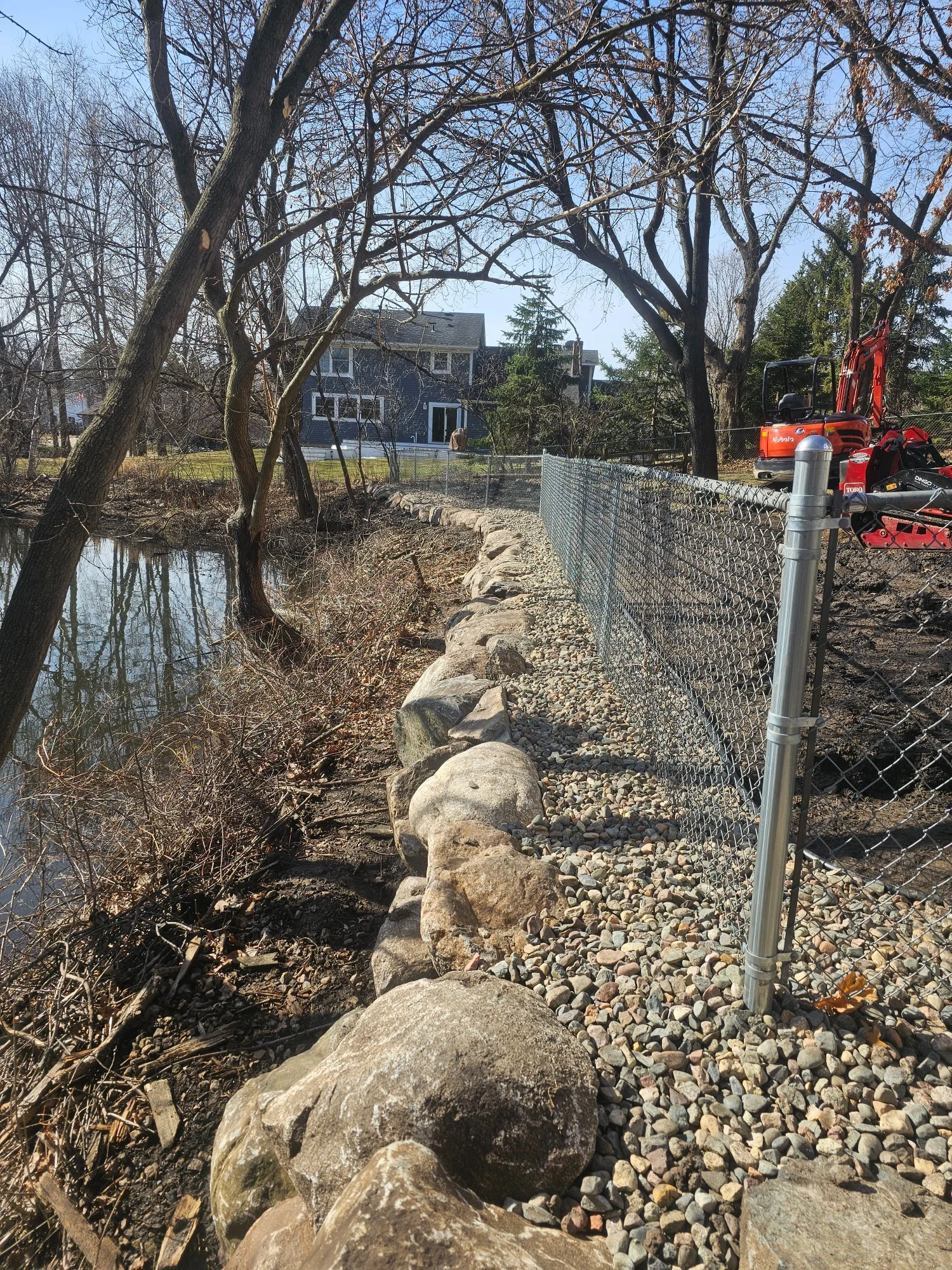 Boulder retaining wall completed along pond — Woodbury MN — Heritage Outdoors 2025