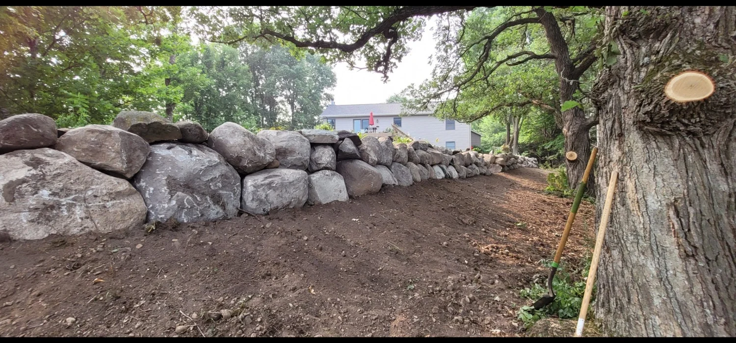 150-foot mosaic boulder retaining wall on private pond property — Grant MN — Heritage Outdoors 2022