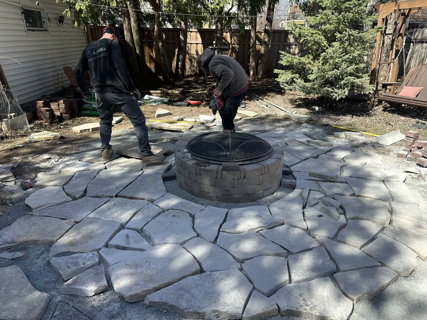 Flagstone firepit patio during installation with Jacob and Haven — Highland Park Saint Paul MN — Heritage Outdoors 2025