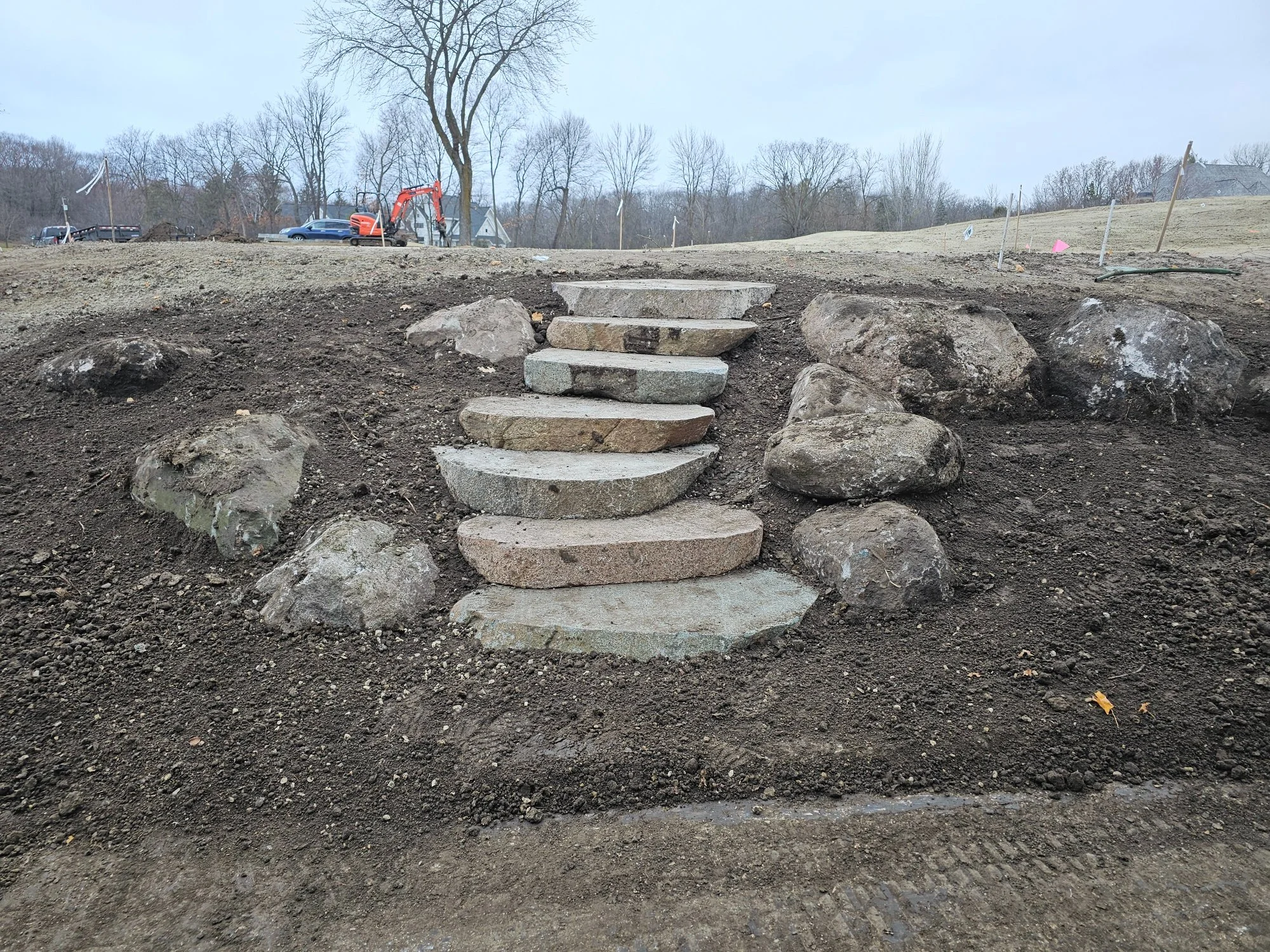 Cut fieldstone boulder steps leading to golf course tee box — Wayzata Country Club — Heritage Outdoors Twin Cities