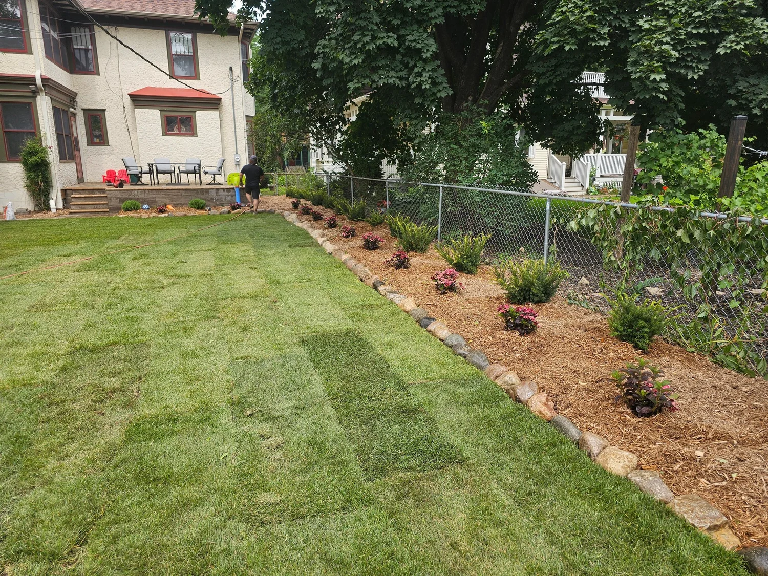 Completed sod with boulder edged garden beds and raised patio — Summit Hill Saint Paul MN — Heritage Outdoors 2025
