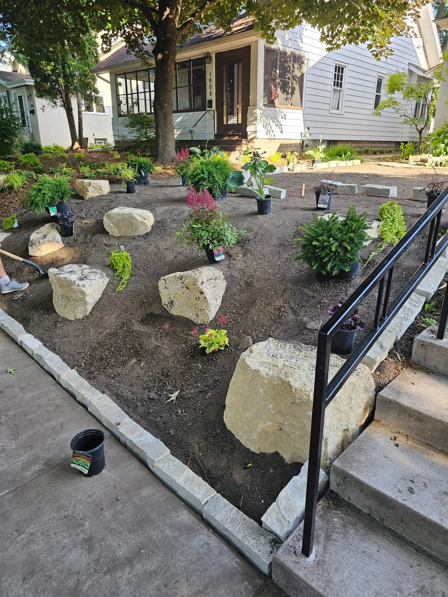 During — limestone blocks and plants being laid out with Fond du Lac Buff edging — Saint Paul MN — Heritage Outdoors 2023