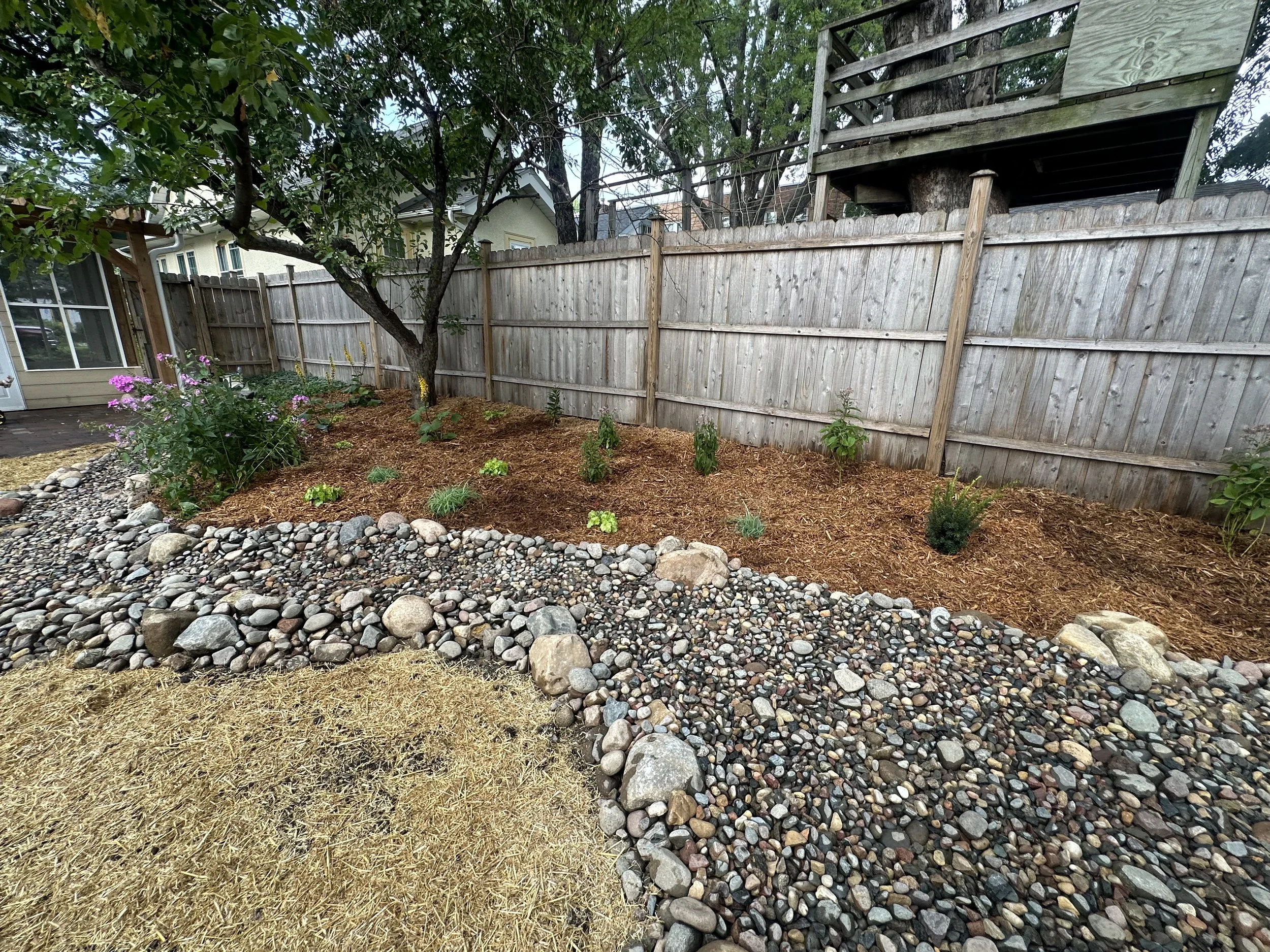 Completed landscape with dry creek bed and garden beds — Hamline-Midway Saint Paul MN — Heritage Outdoors 2025