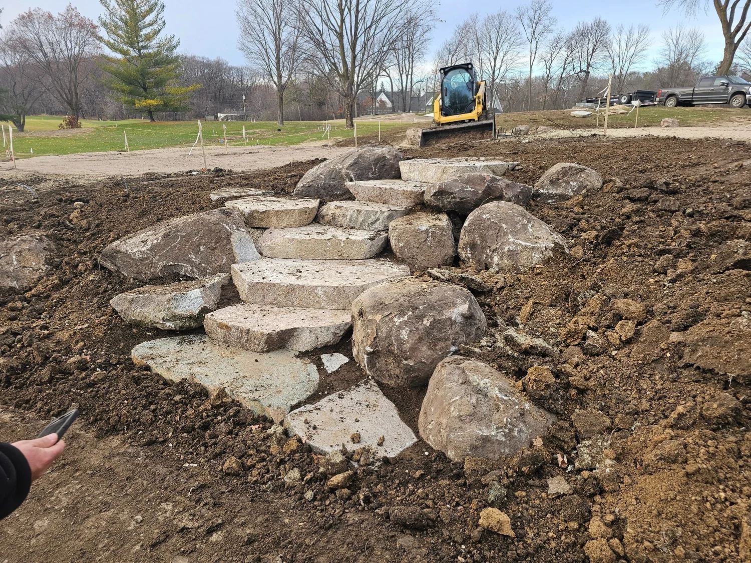 Flat cut-face fieldstone granite steps with boulder outcroppings — Wayzata MN — Heritage Outdoors
