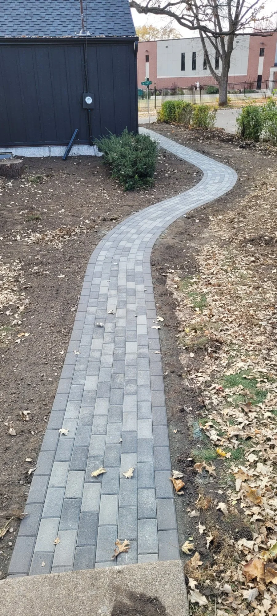 Willow Creek Charcoal Blend curved paver walkway with black border winding to garage — Saint Louis Park MN — Heritage Outdoors 2022