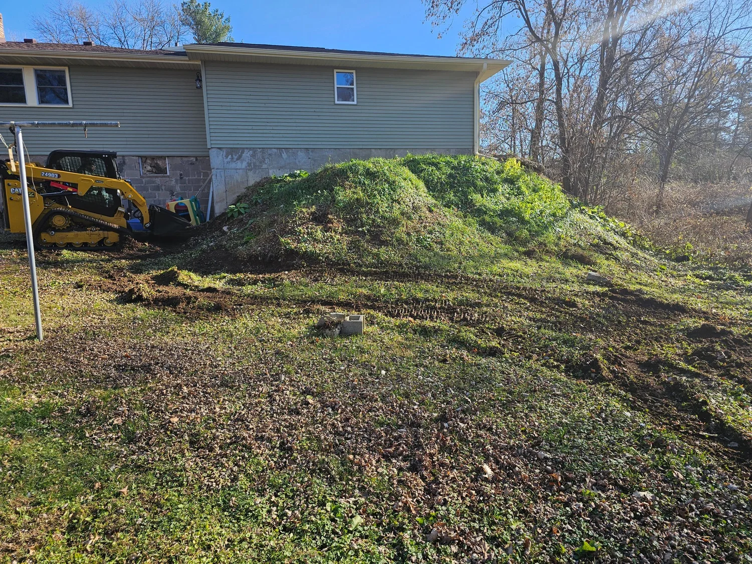 CAT skid steer on site before boulder wall install — Lake Elmo MN — Heritage Outdoors
