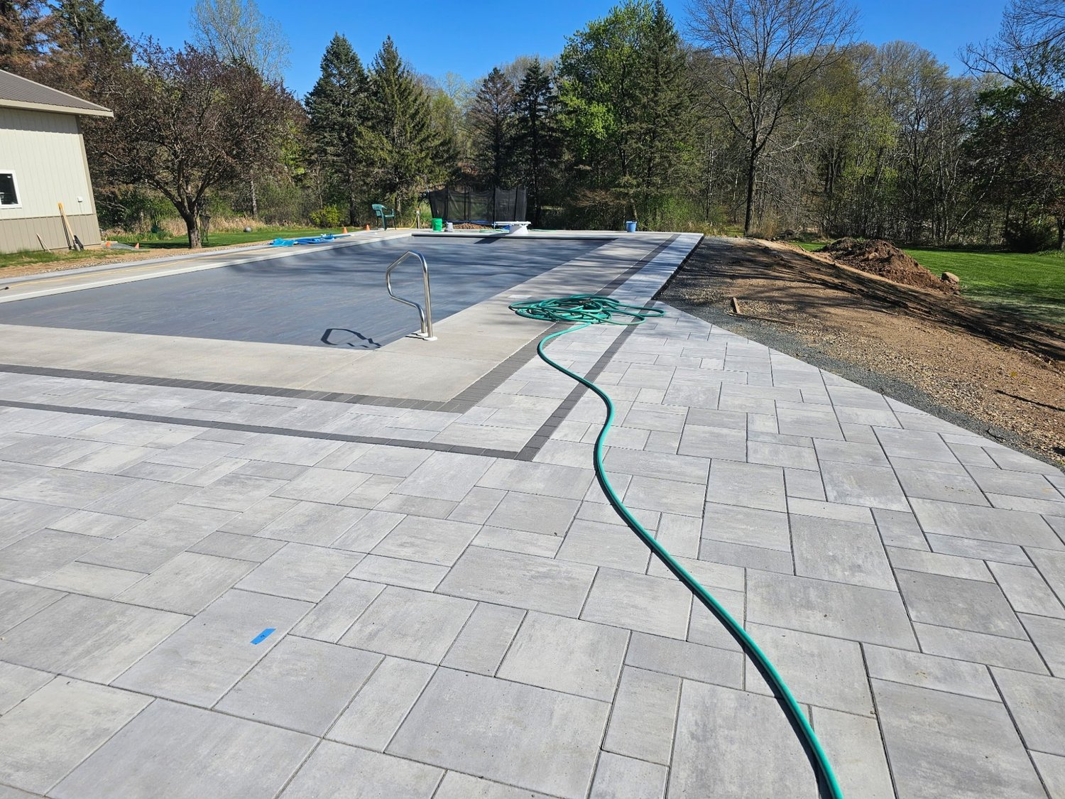 Unilock Beacon Hill pool deck field laid during installation — Lake Elmo MN — Heritage Outdoors