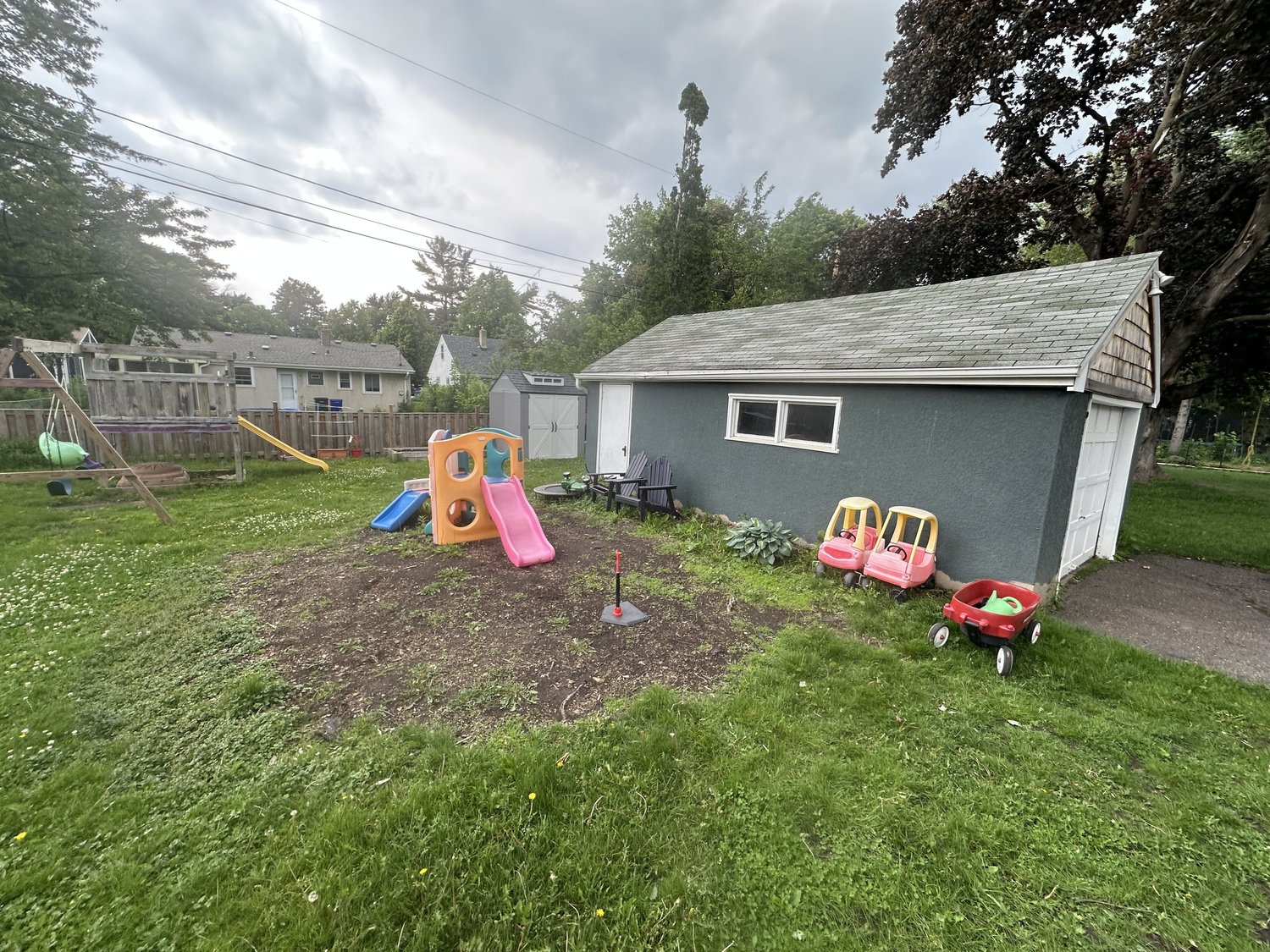 Backyard before paver patio — muddy bare dirt after tree removal — Como Park Saint Paul MN — Heritage Outdoors 2025