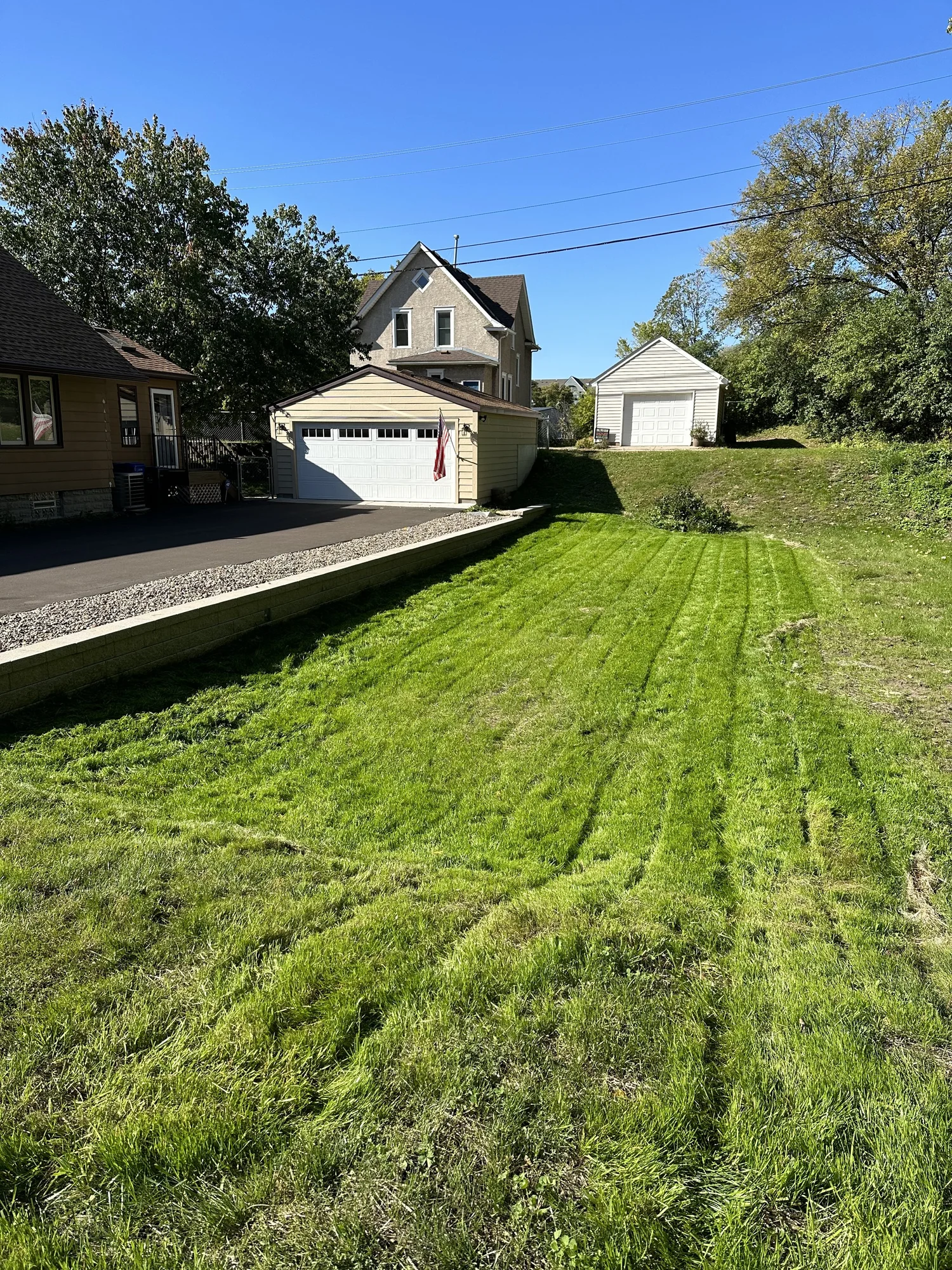 Versa-Lok retaining wall with decorative river rock — finished driveway edge Como Park Saint Paul MN — Heritage Outdoors