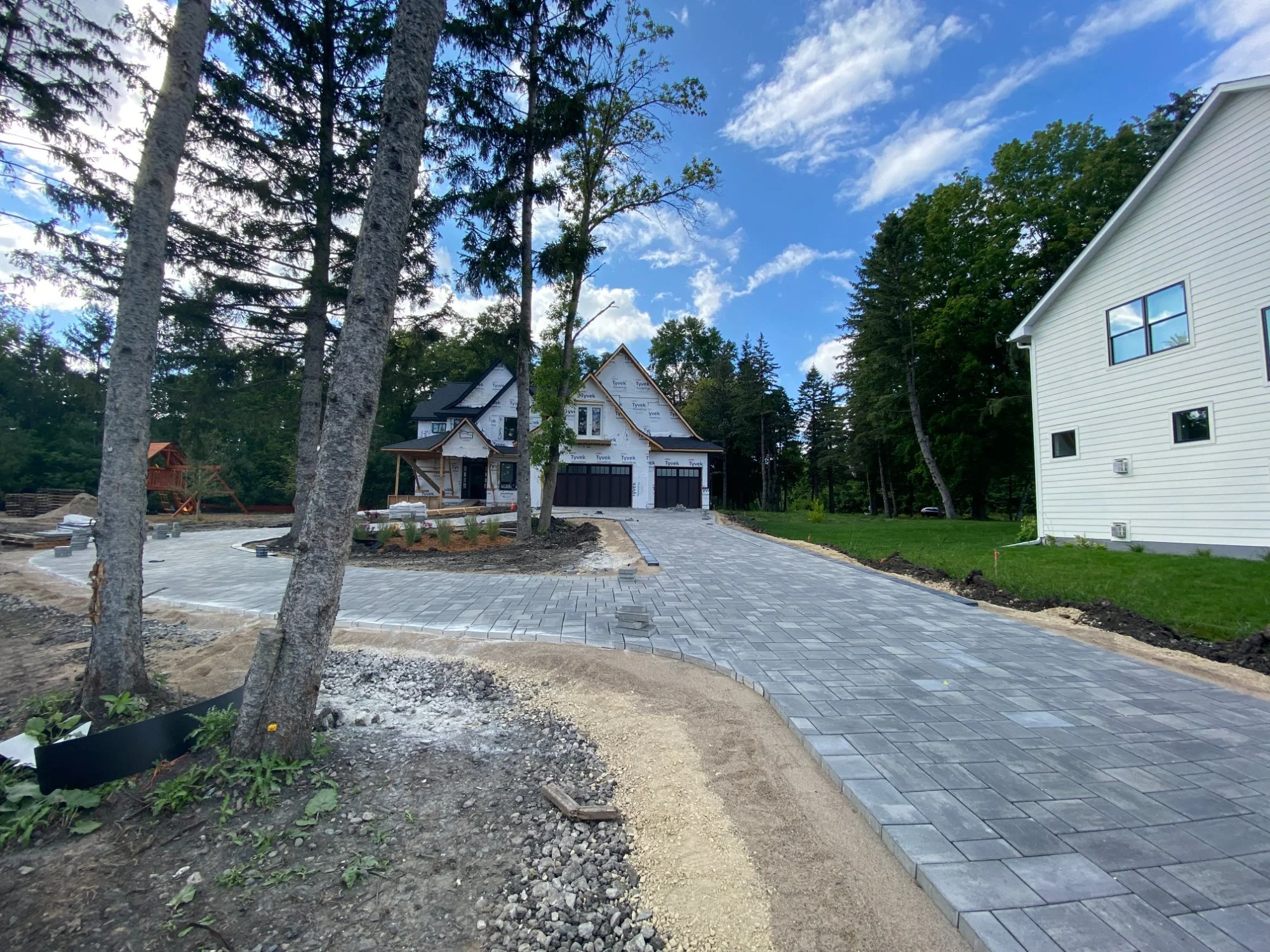 Unilock Treo Smooth circular turnaround driveway taking shape — Plymouth MN — Heritage Outdoors
