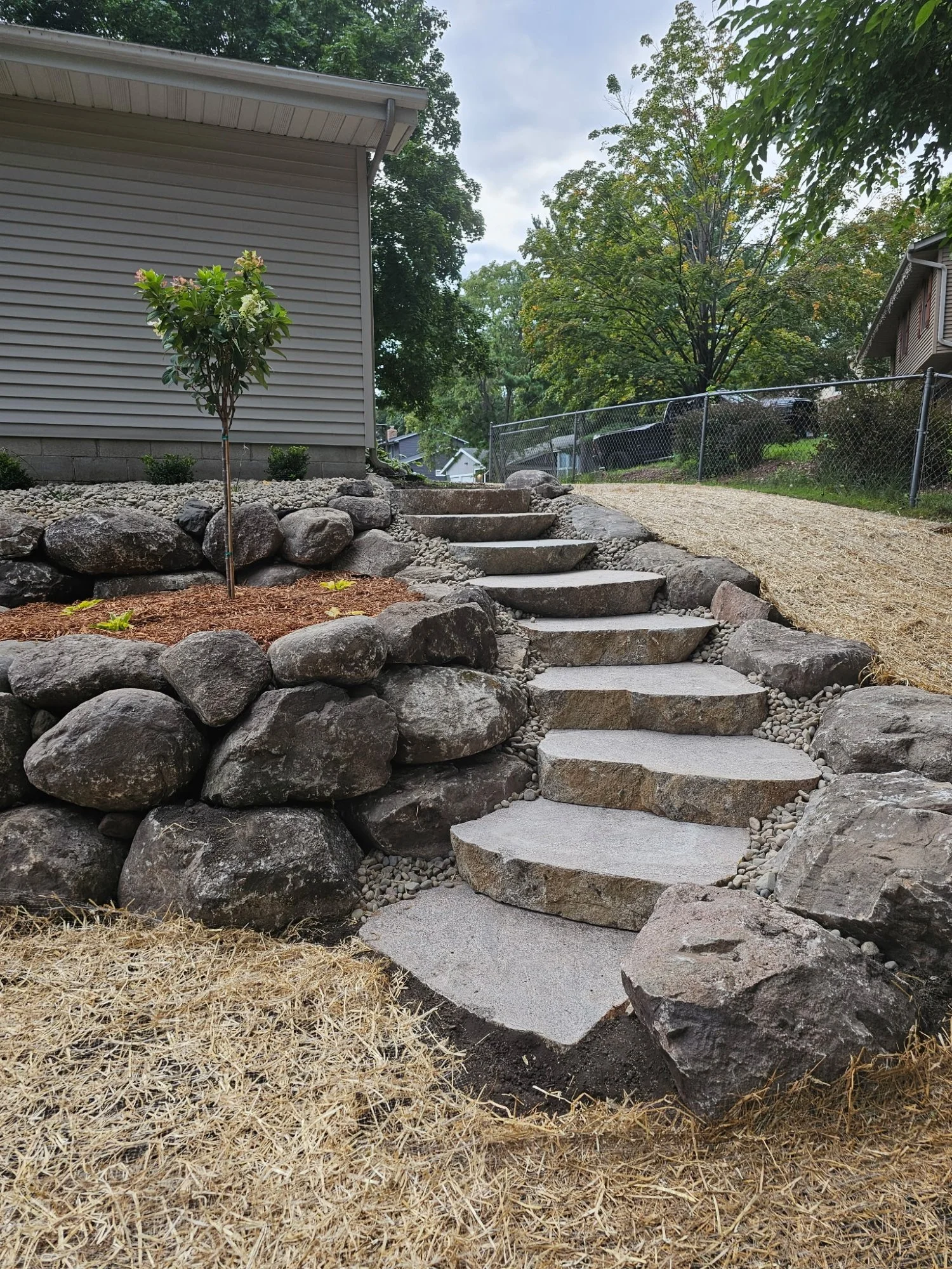 Cut boulder steps and tiered wall side view — Woodbury MN — Heritage Outdoors 2025