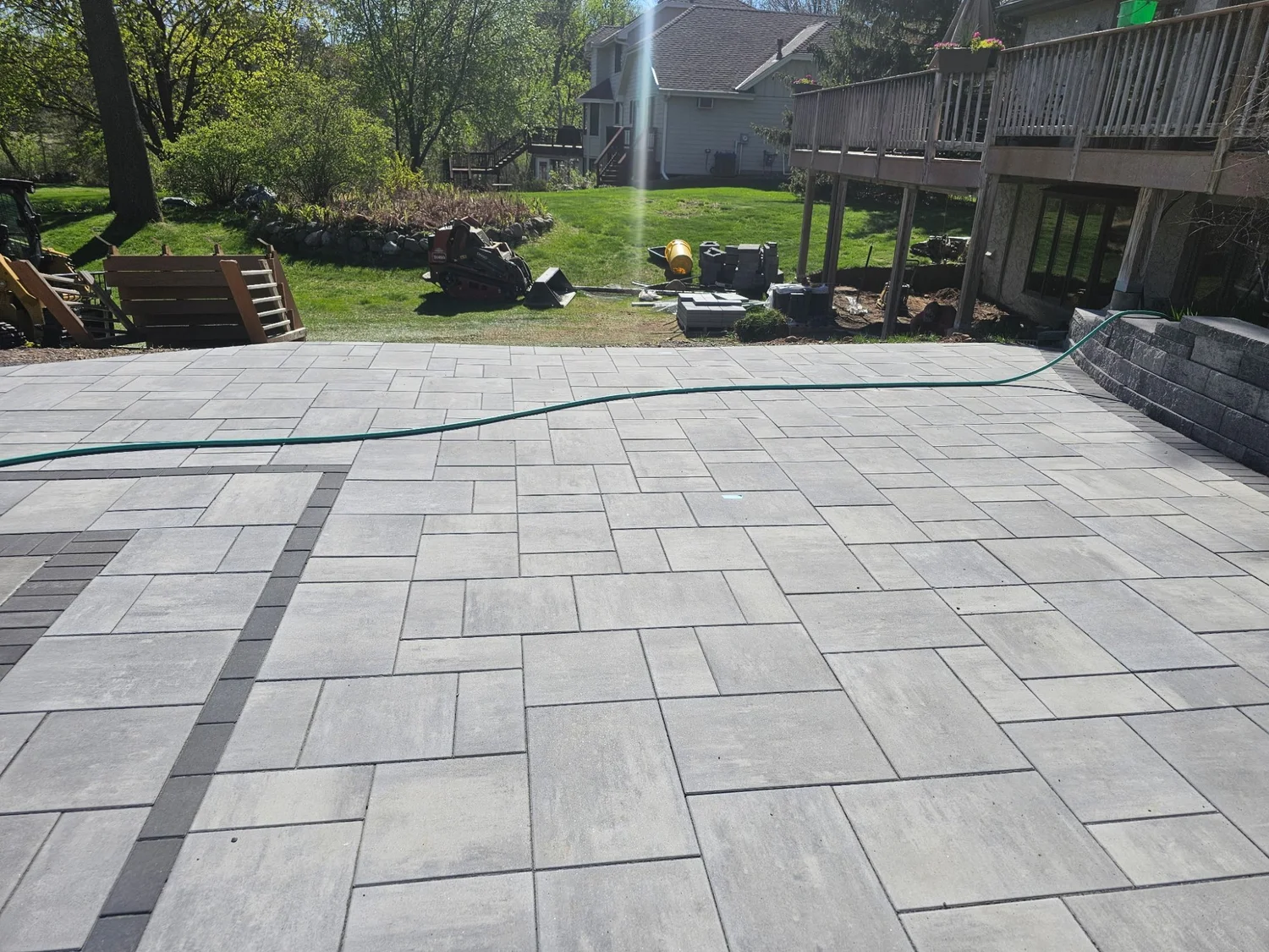 Completed Unilock Beacon Hill pool deck with dark charcoal border — Lake Elmo MN — Heritage Outdoors