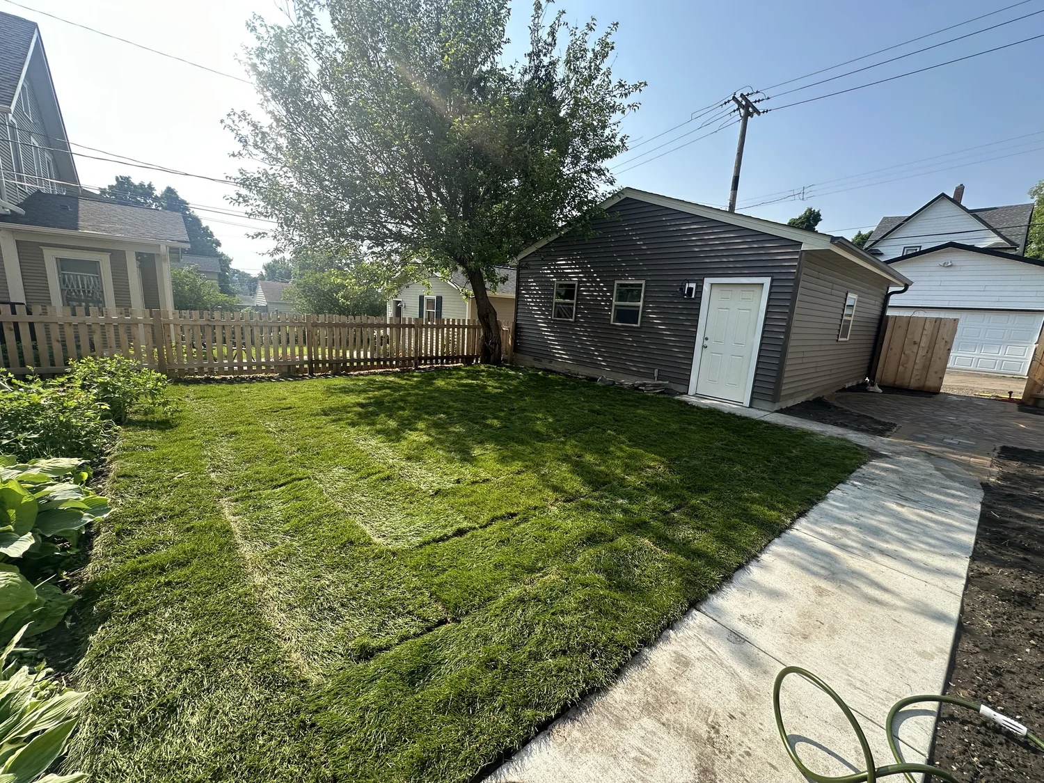 Fresh sod backyard with new garage and circle patio — Mac-Groveland Saint Paul MN — Heritage Outdoors 2025