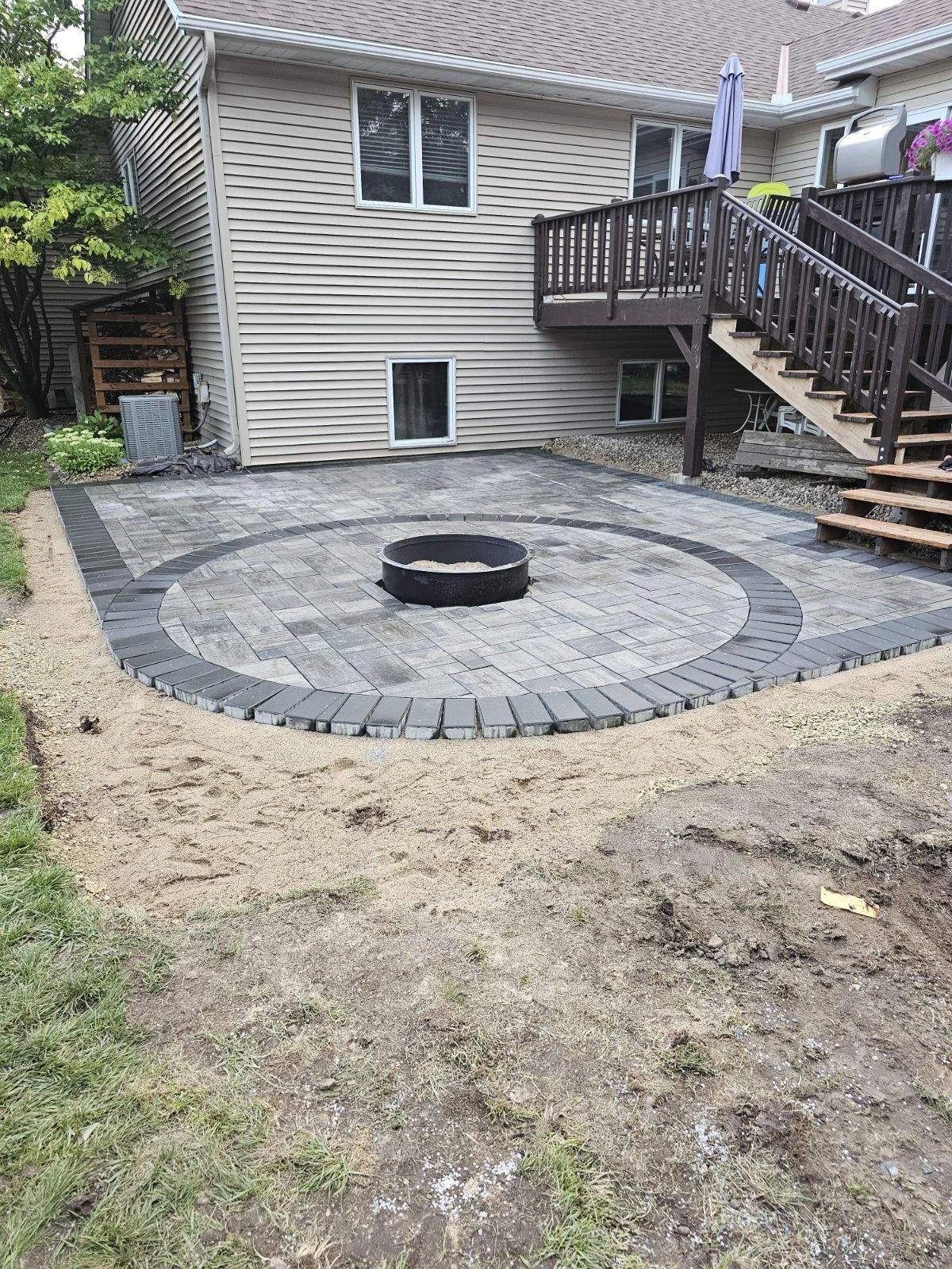 RCP Reno paver patio circle fire pit feature during installation — Woodbury MN — Heritage Outdoors 2024