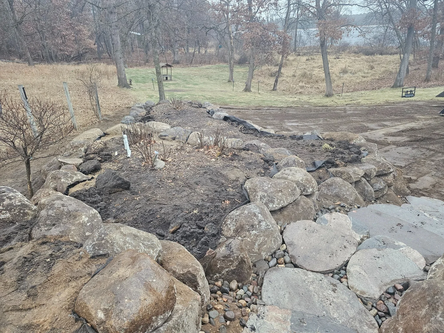 View from top of completed boulder wall looking out over Wyoming MN property — Heritage Outdoors