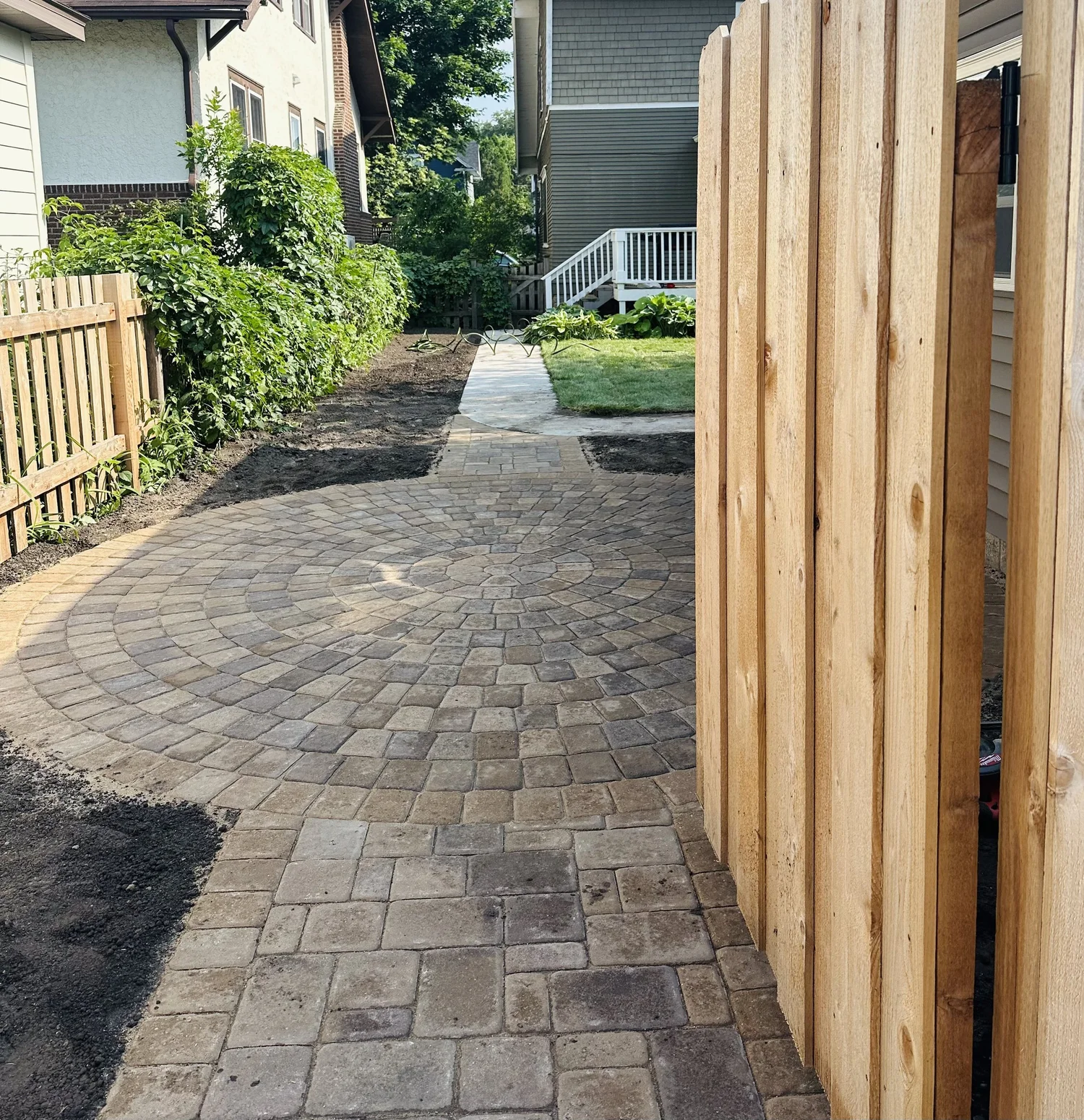 Willow Creek Chestnut connecting walkway leading to circle patio through fence gate — Mac-Groveland Saint Paul MN — Heritage Outdoors 2025