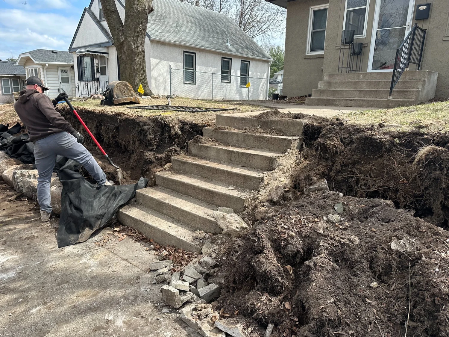 Concrete block wall demo and early boulder placement — Maplewood MN — Heritage Outdoors crew