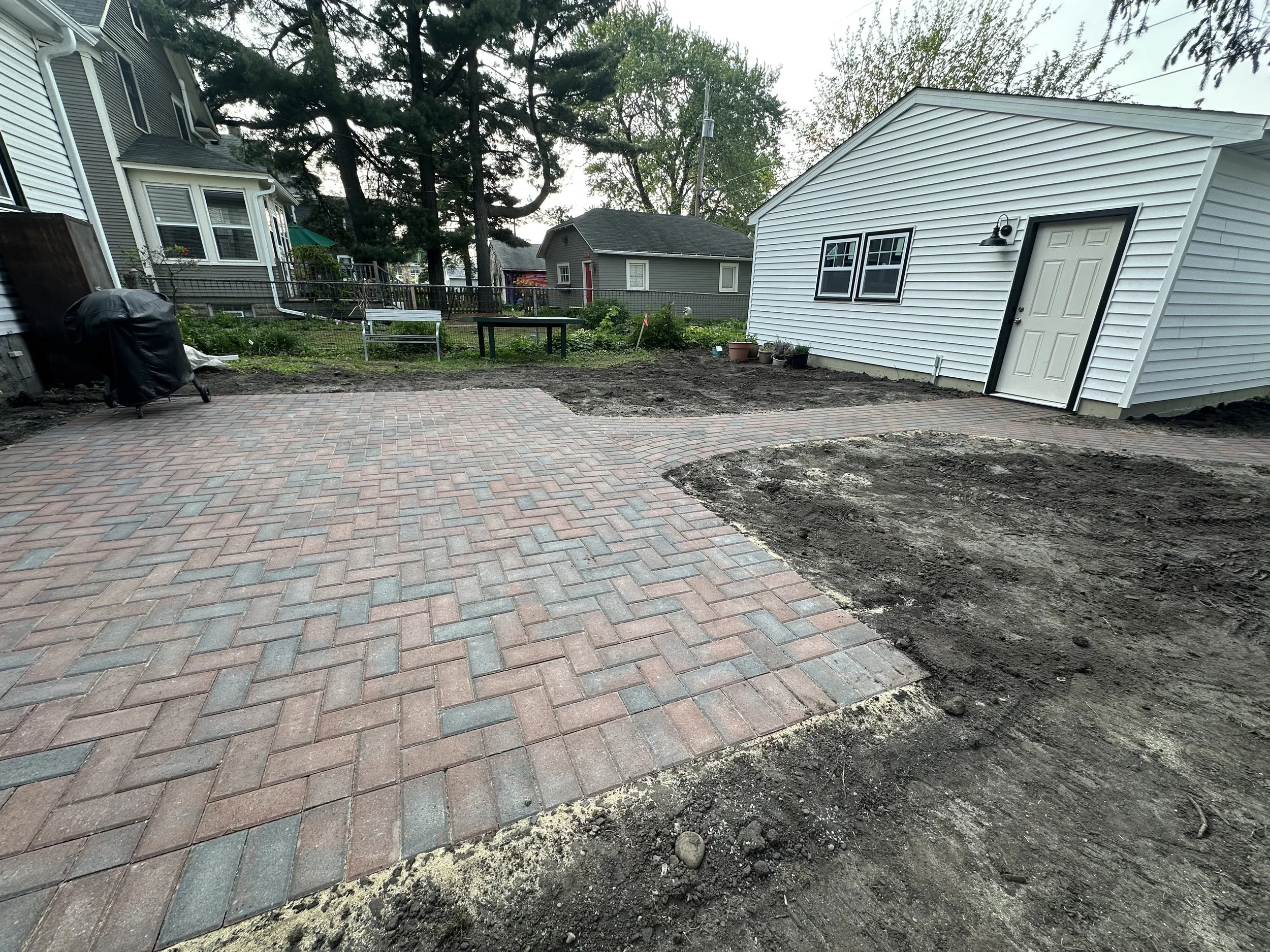 Completed Willow Creek Brickstone RoseCreek herringbone patio wide view with new garage — Hamline-Midway Saint Paul MN — Heritage Outdoors 2025