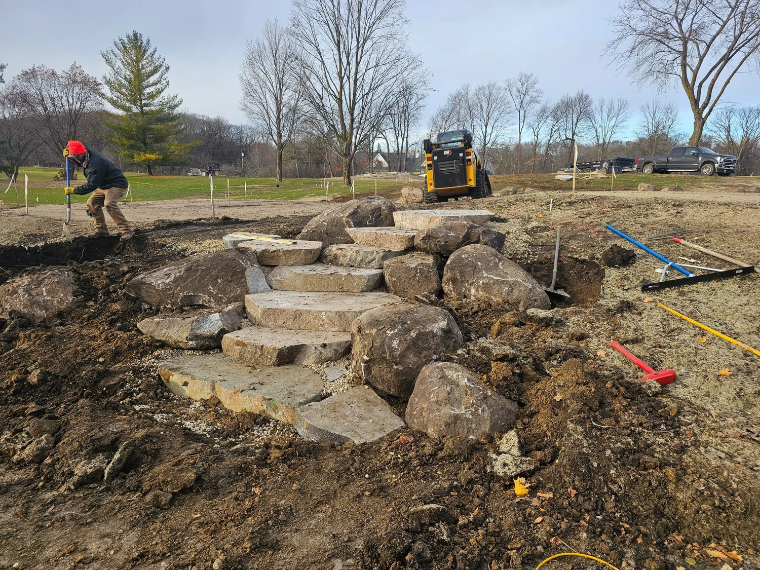 Heritage Outdoors crew installing boulder steps on Wayzata Country Club golf course — late November 2024