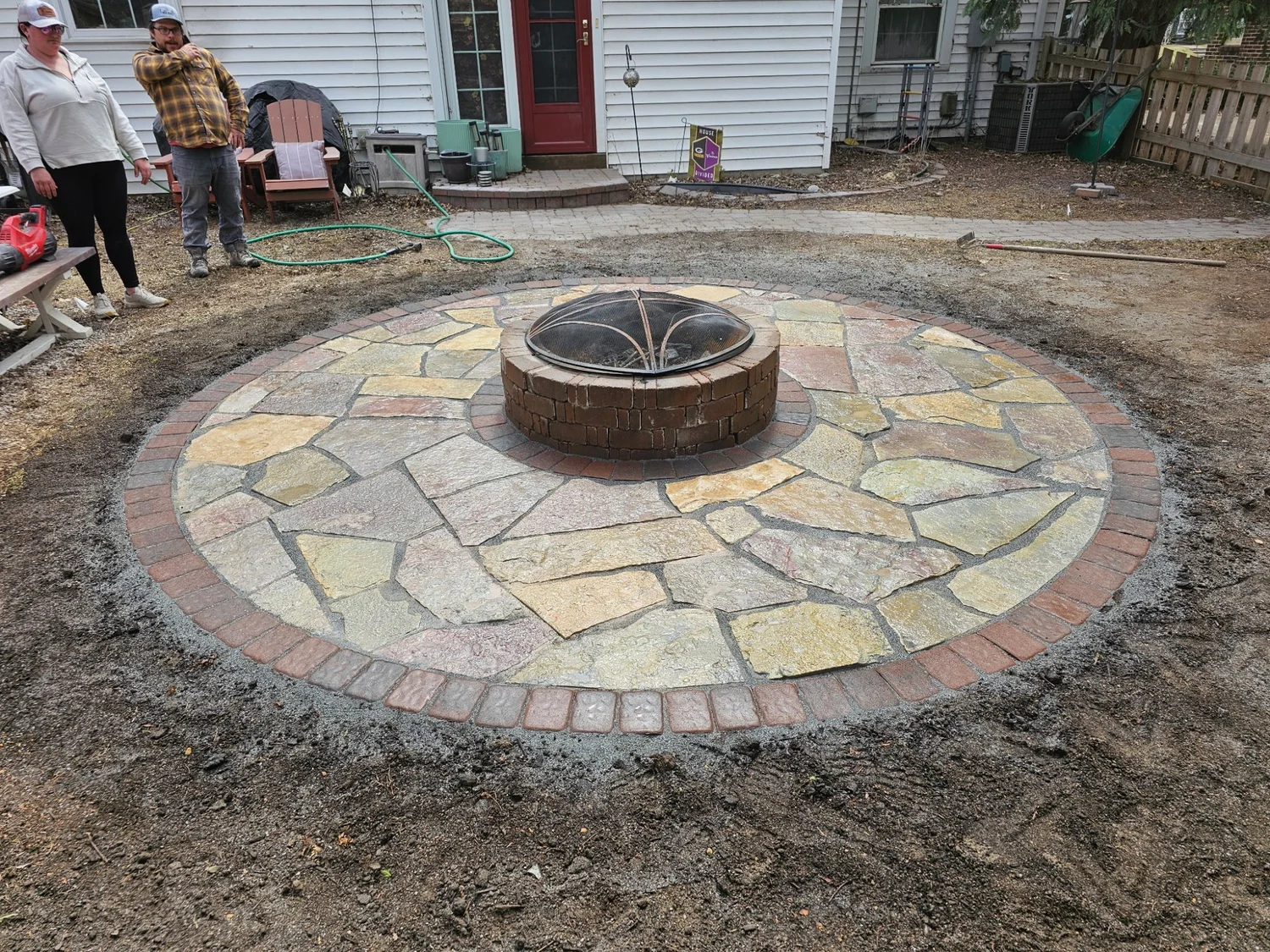 Flagstone firepit patio during installation — Highland Park Saint Paul MN — Heritage Outdoors 2025