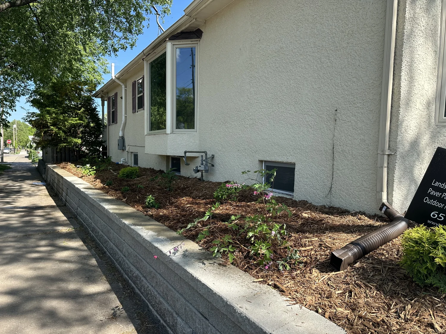 Versa-Lok retaining wall with completed spring landscape install — Longfellow Minneapolis MN — Heritage Outdoors 2024