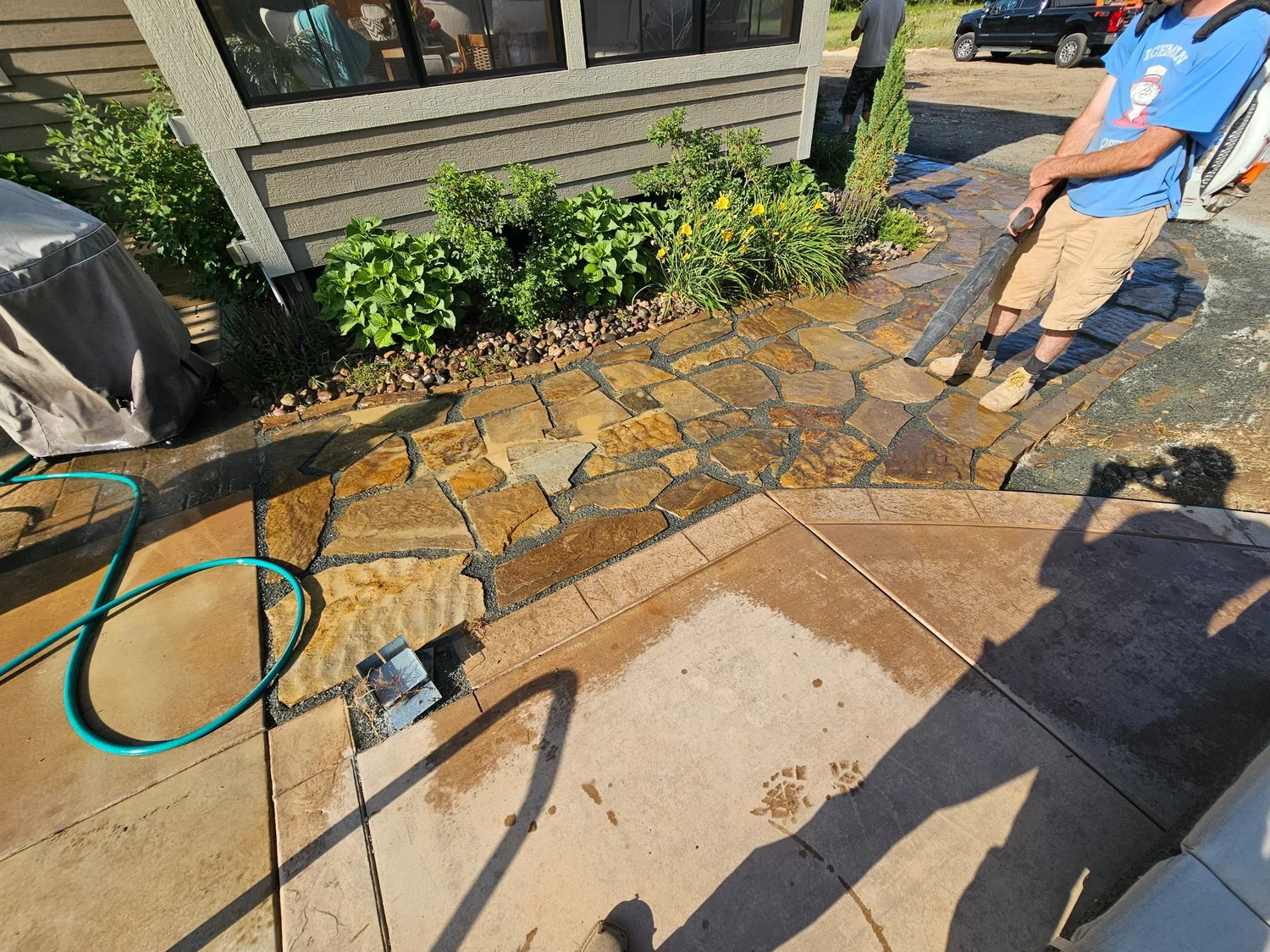 Natural stone walkway transitioning to existing patio — West Lakeland Township MN — Heritage Outdoors 2023