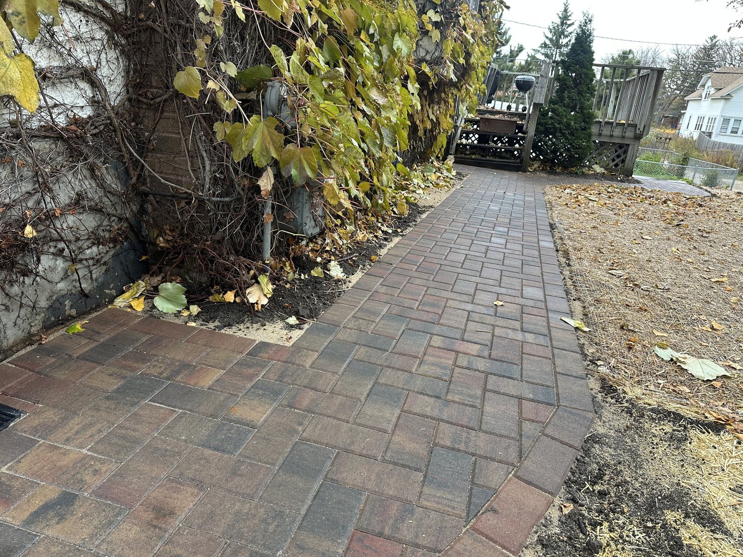 Completed paver walkway length view along house — Como Park Saint Paul — Heritage Outdoors 2025