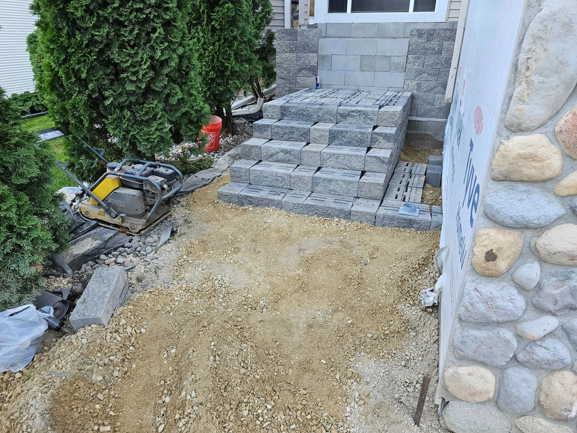 Block stoop steps taking shape with plate compactor on site — Burnsville MN — Heritage Outdoors